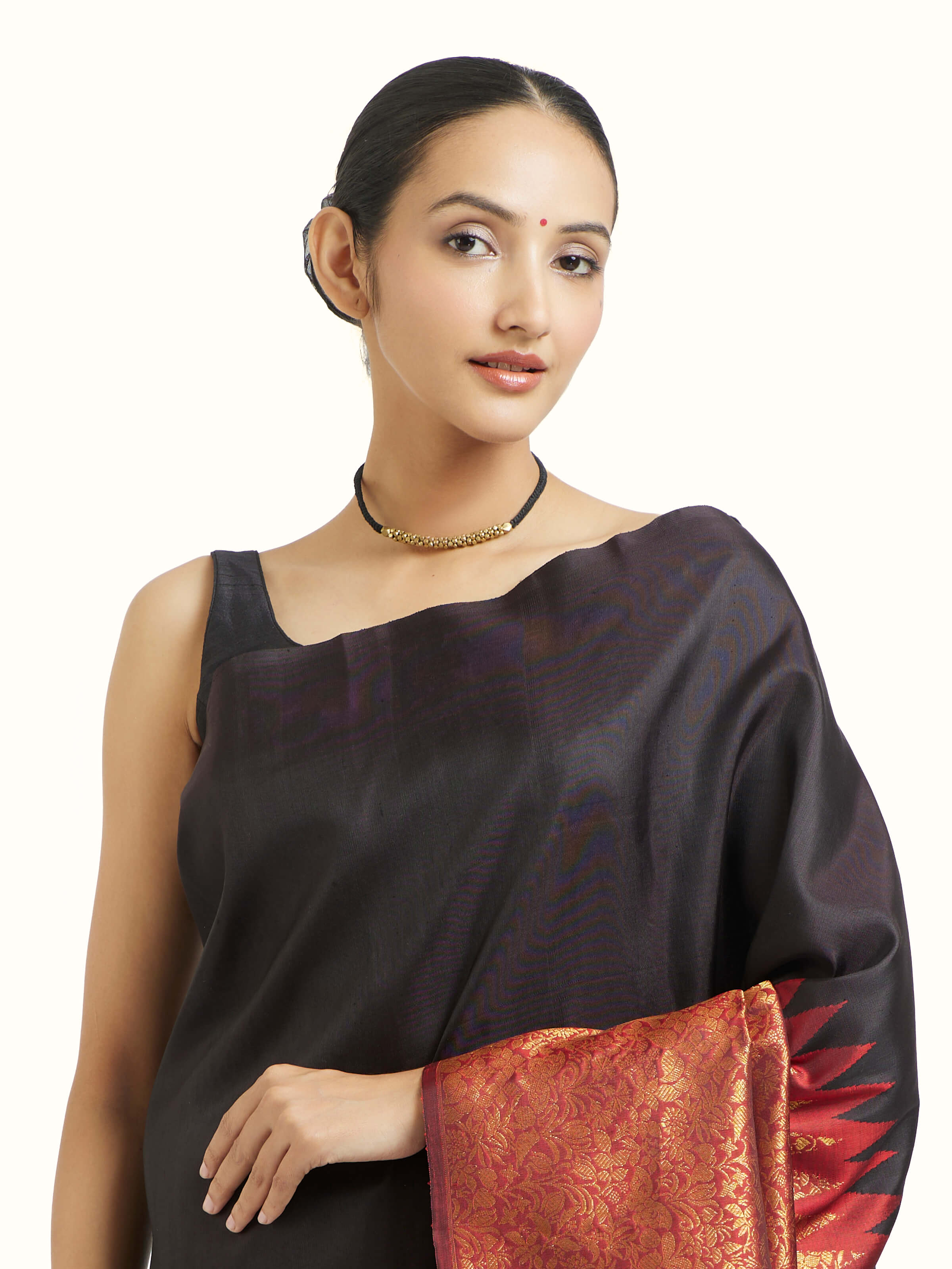Angled view of black silk Kancheepuram saree highlighting intricate zari craftsmanship