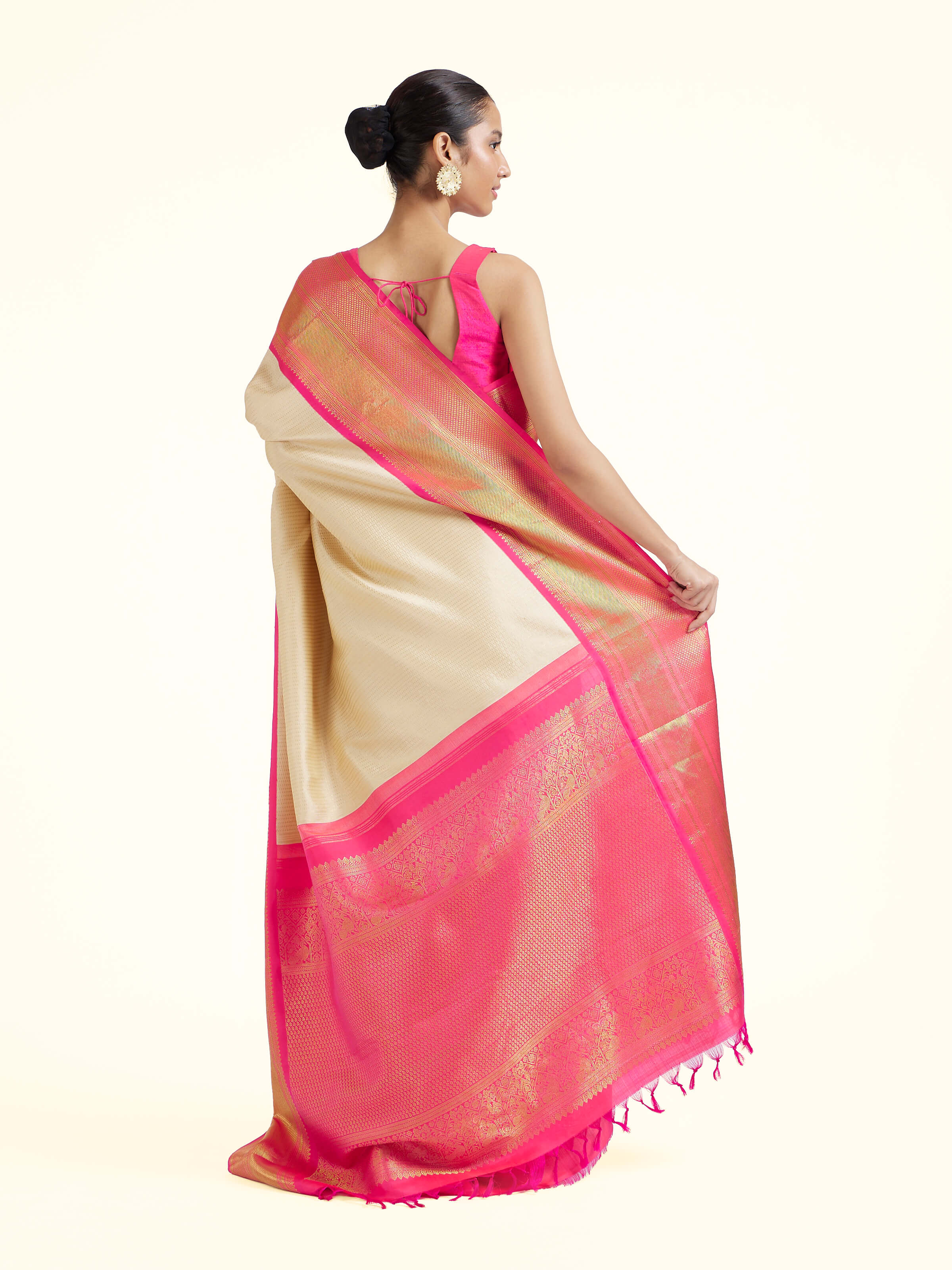 Back view of cream silk Kancheepuram saree displaying ornate pallu design