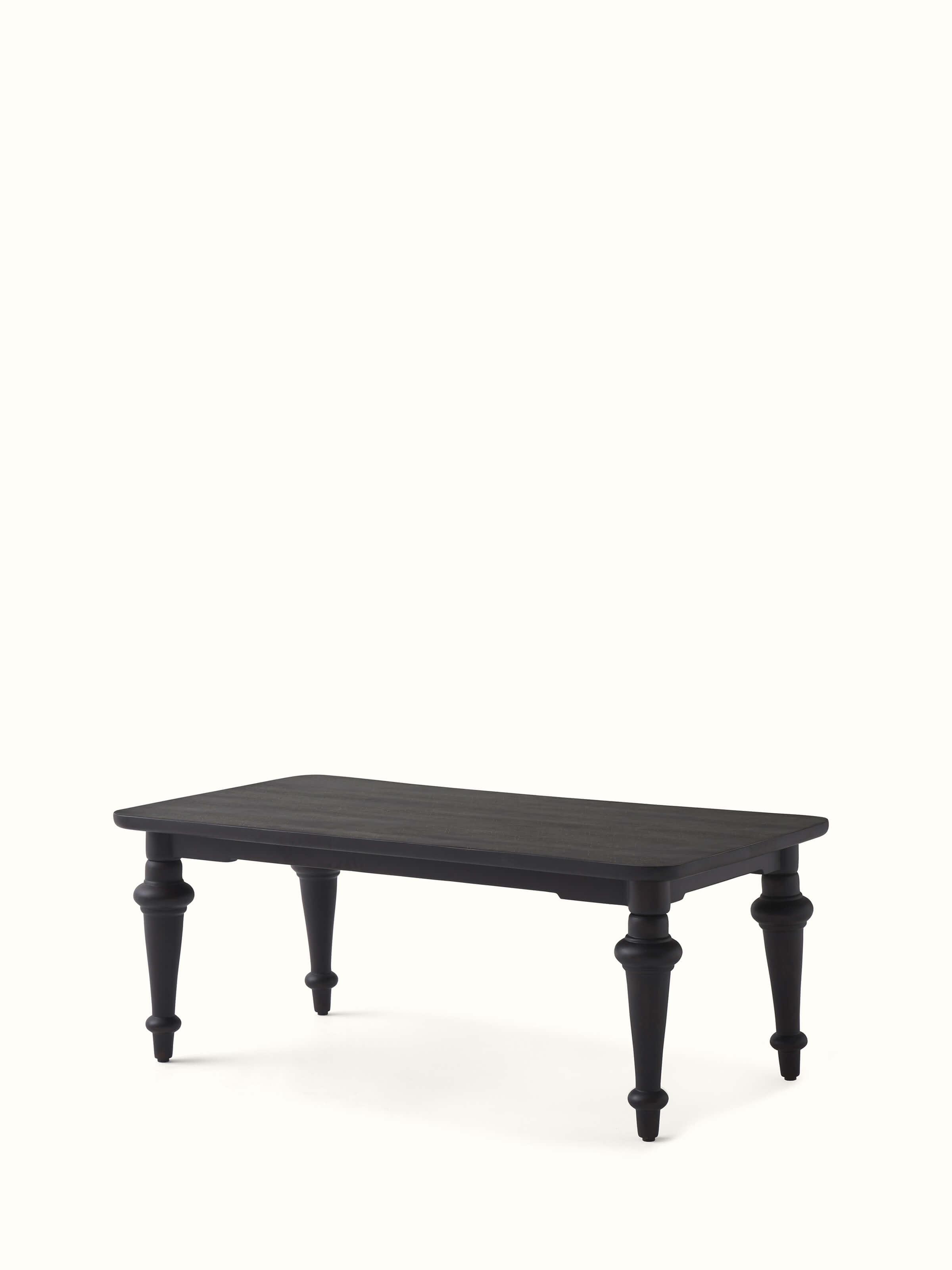 Side view of the Sheesham wood coffee table, emphasizing its sleek design and brass inlay details