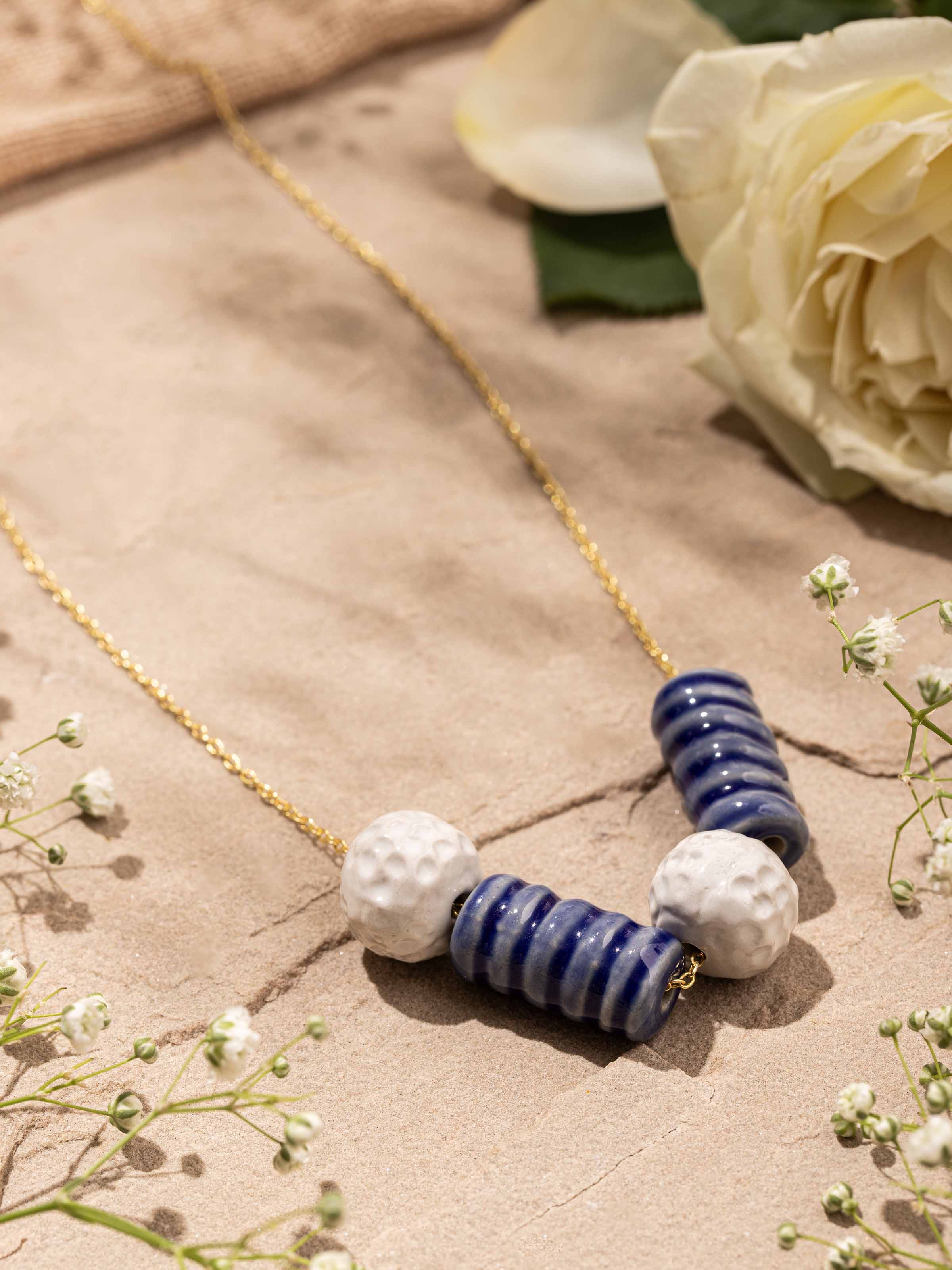 Close-up detail of ceramic beadwork with smooth finish on necklace