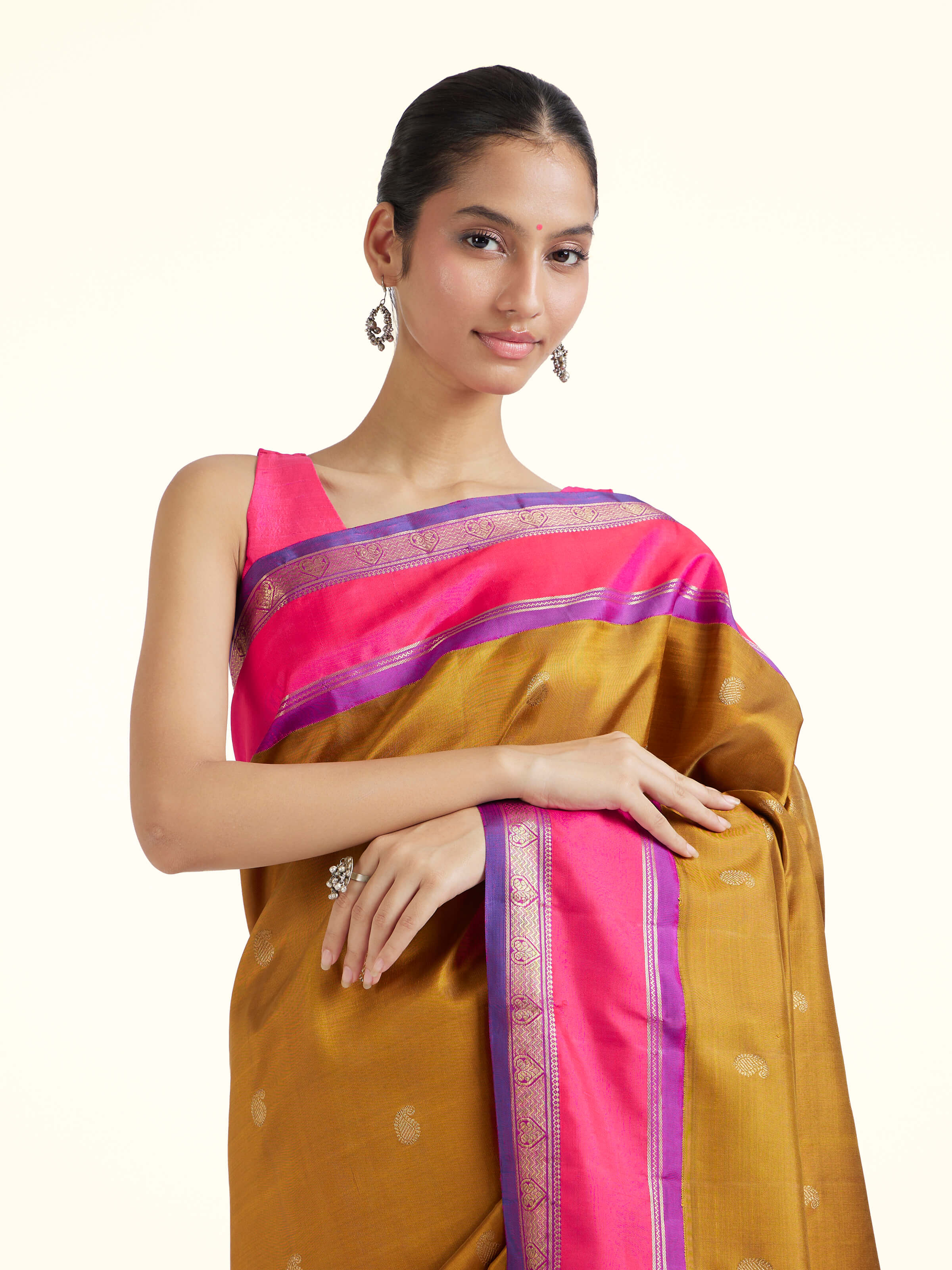 Angled view of olive silk Kancheepuram saree highlighting traditional weave and lustrous sheen