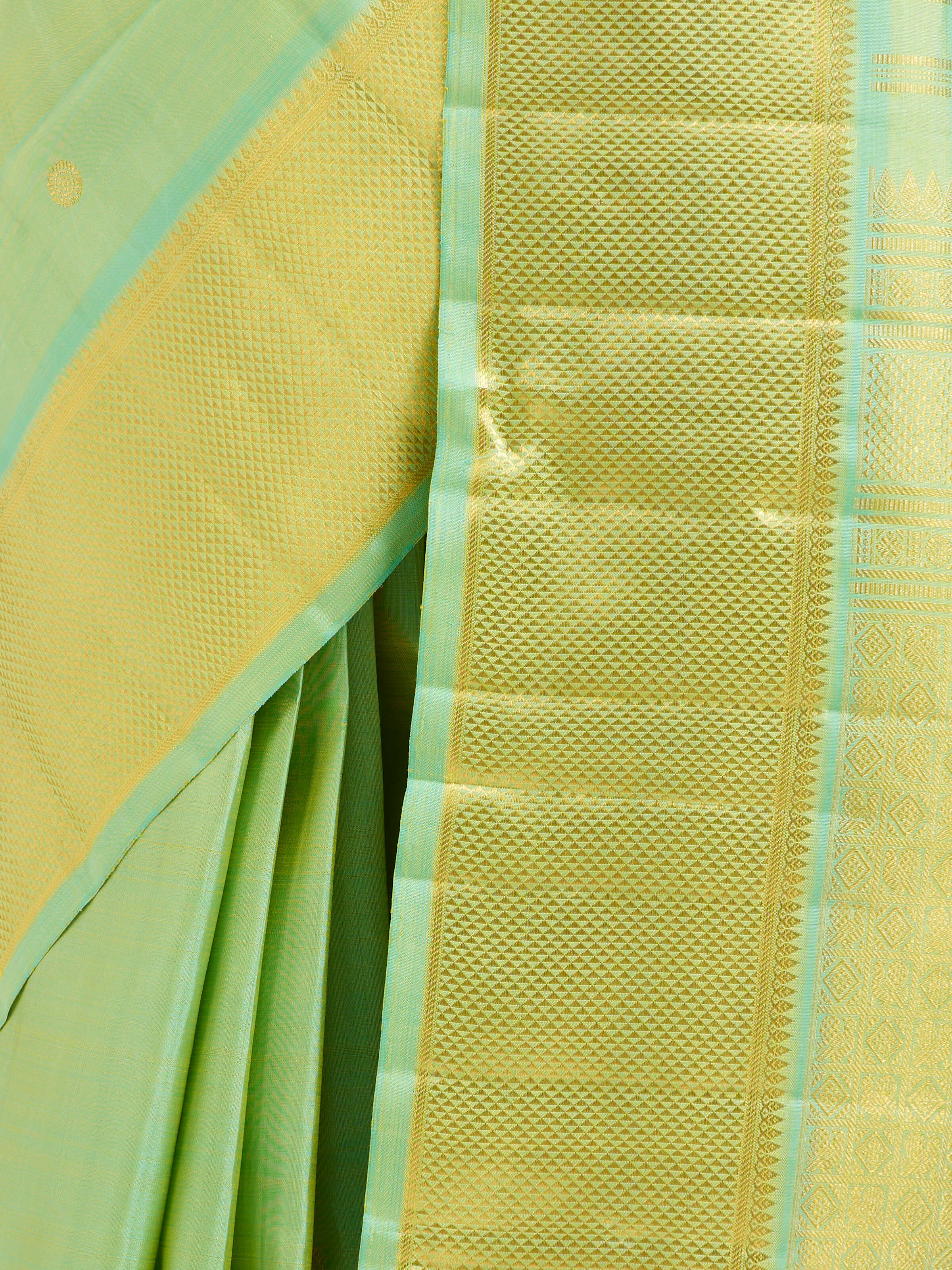 Detail view of green silk Kancheepuram saree showing silk texture and zari craftsmanship