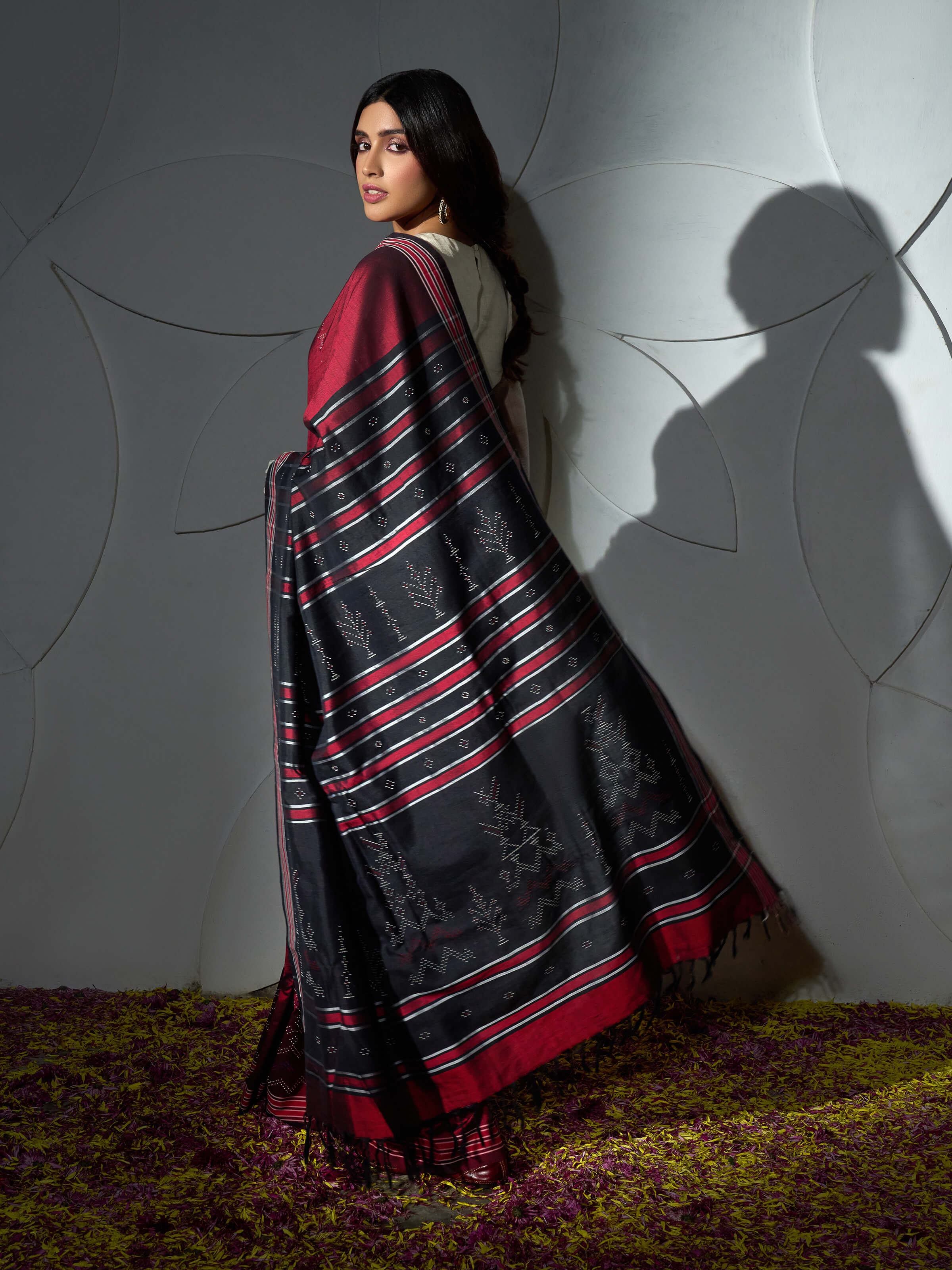 Angled view of maroon cotton silk tangalia saree highlighting tangalia weaving technique