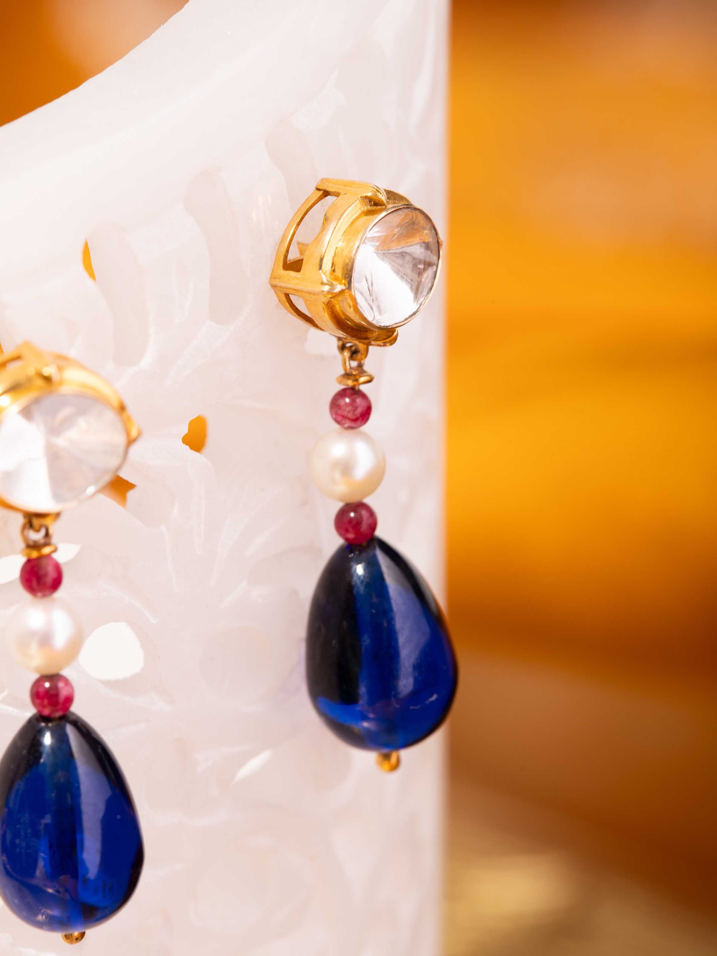 Overhead view focusing on the symmetrical teardrop design and handcrafted setting of each stone.