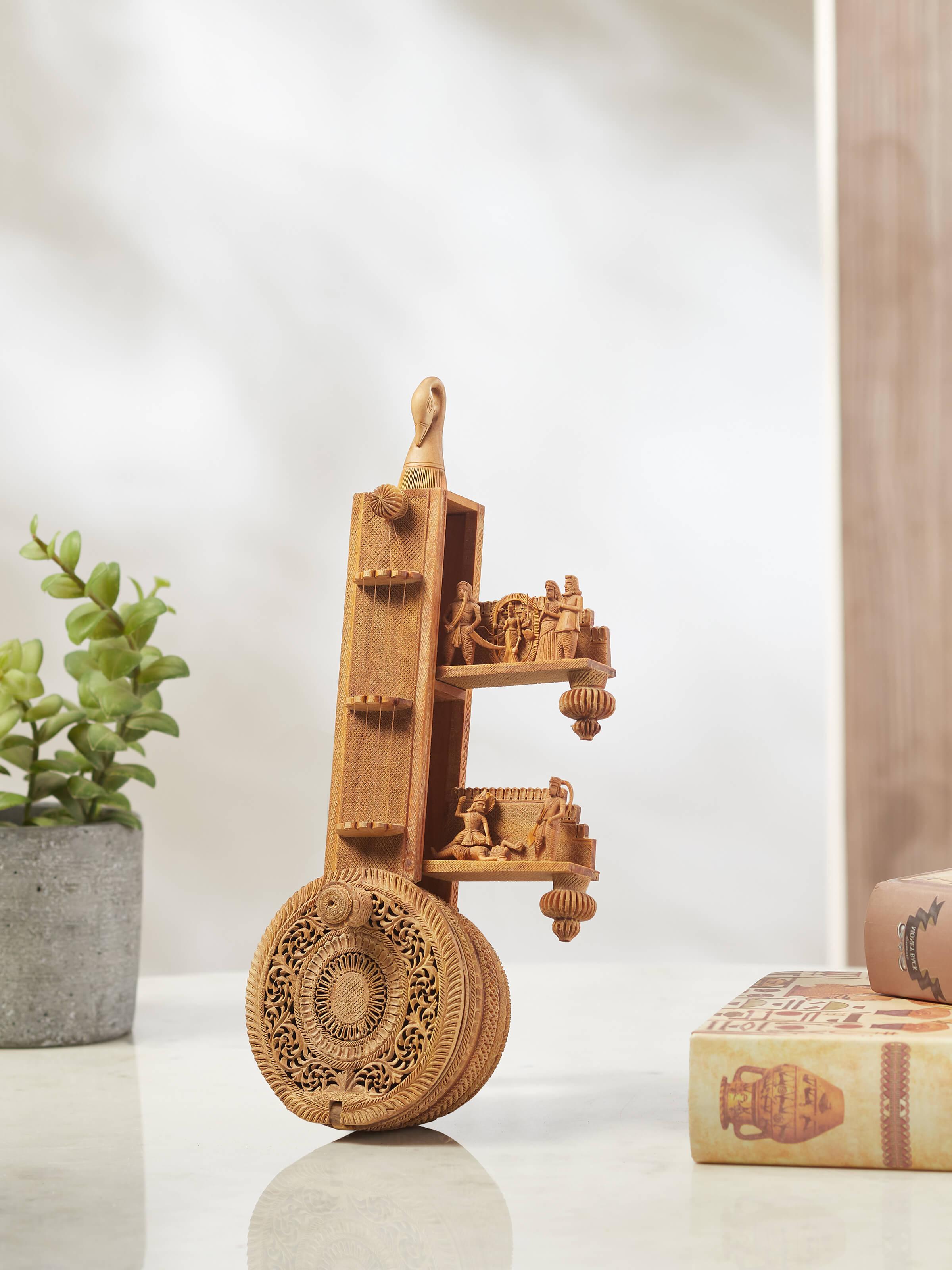 Side view of carved sandalwood devotion veena sculpture, highlighting the detailed woodwork and craftsmanship.