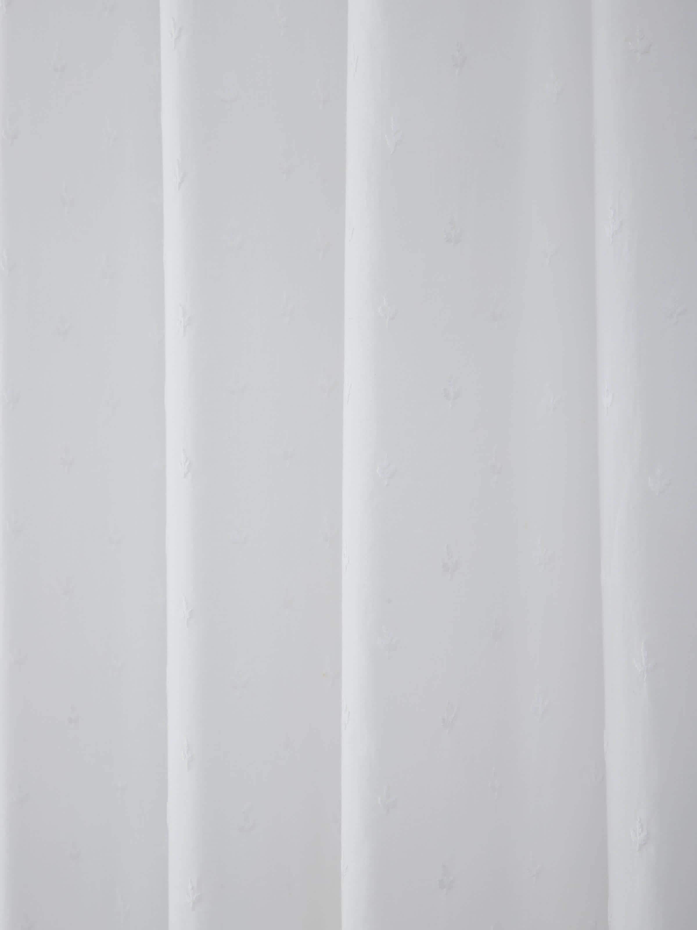 Detail shot highlighting delicate Chikankari work on white cotton curtain.