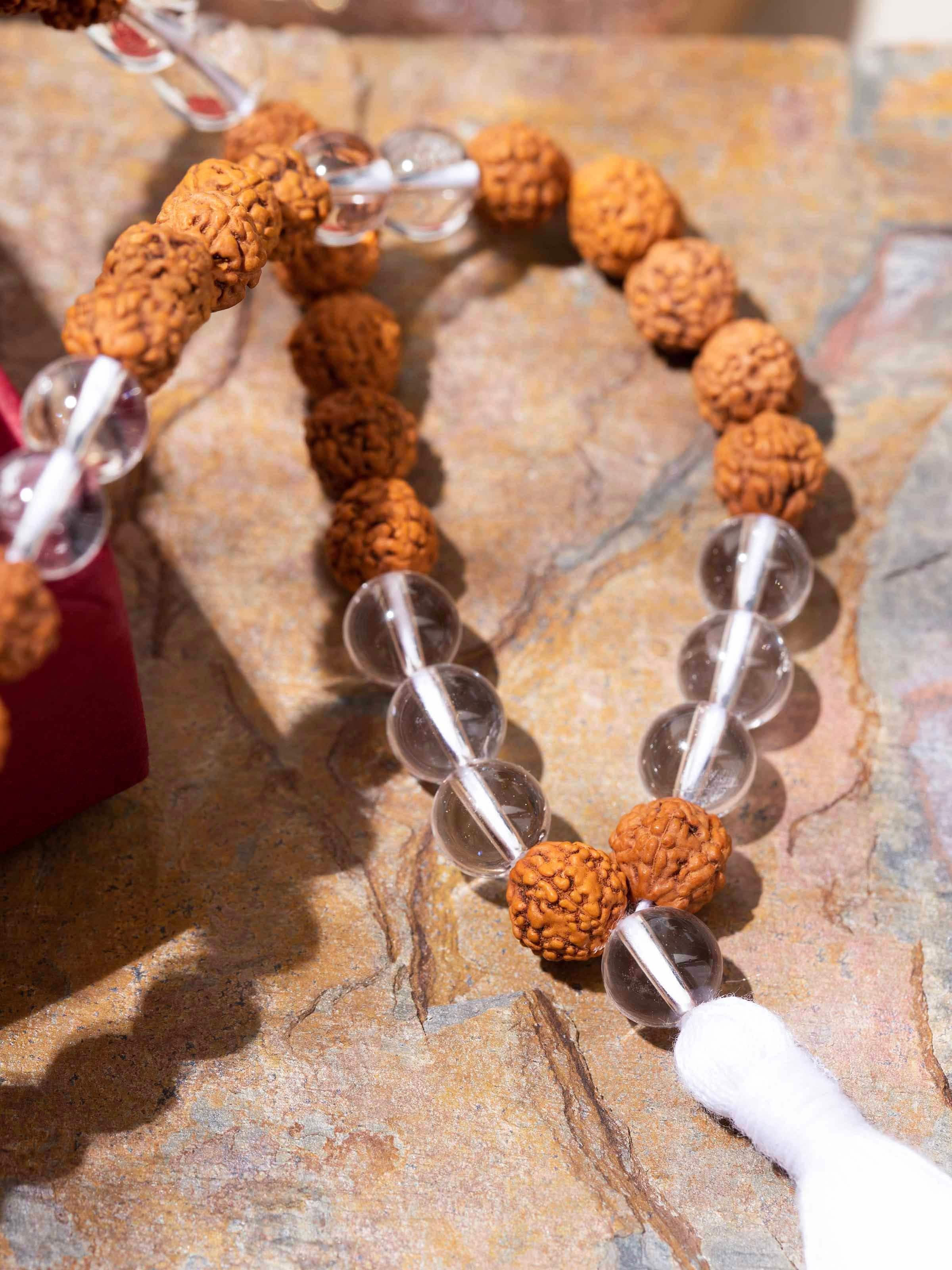 Angled view of Rudraksha & Sphatik Mala showcasing reflective Sphatik stones and symbolic balance