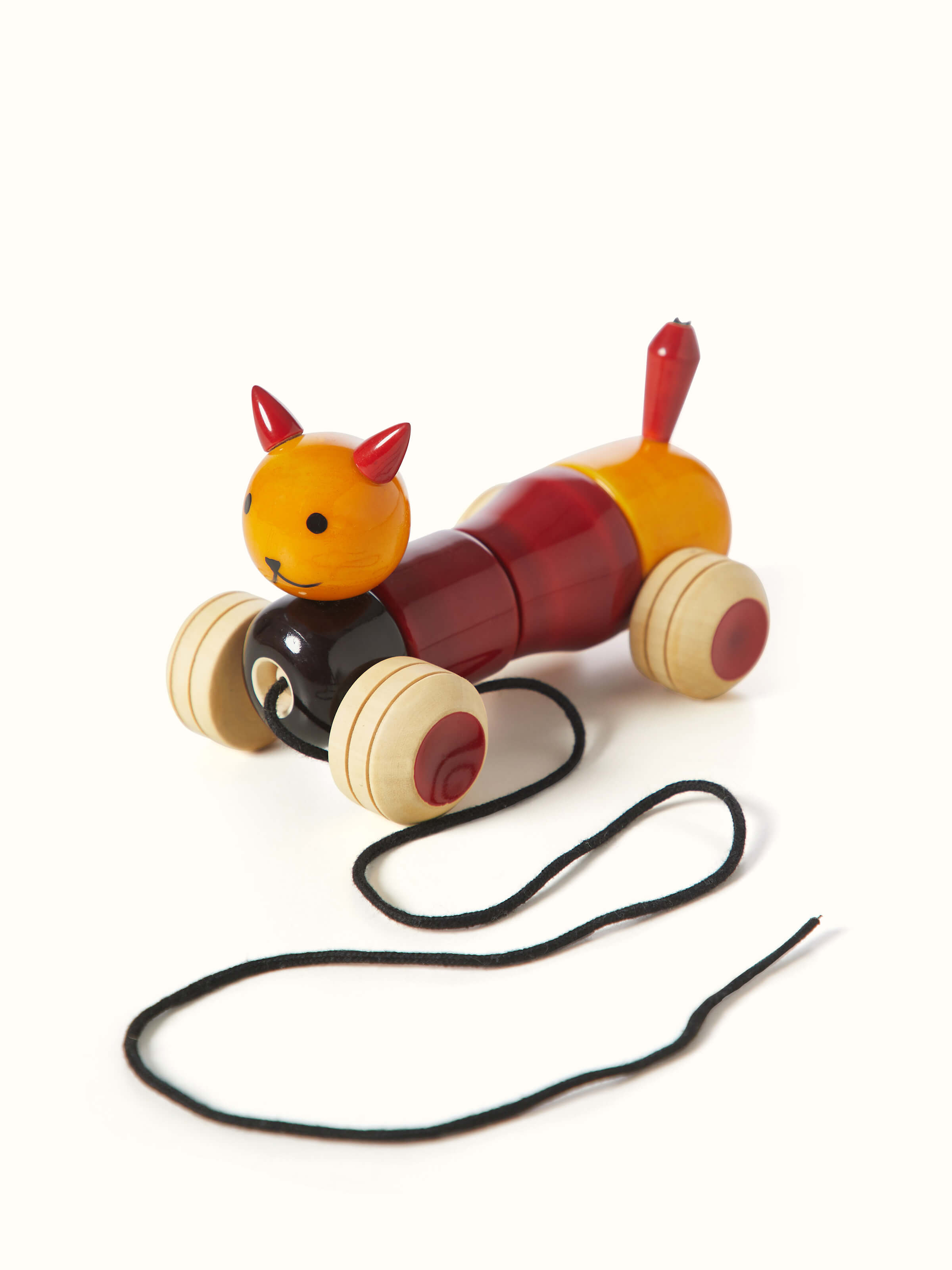 Side view of Channapatna ivory wood bovow yellow toy, highlighting its elegant shape and finish.