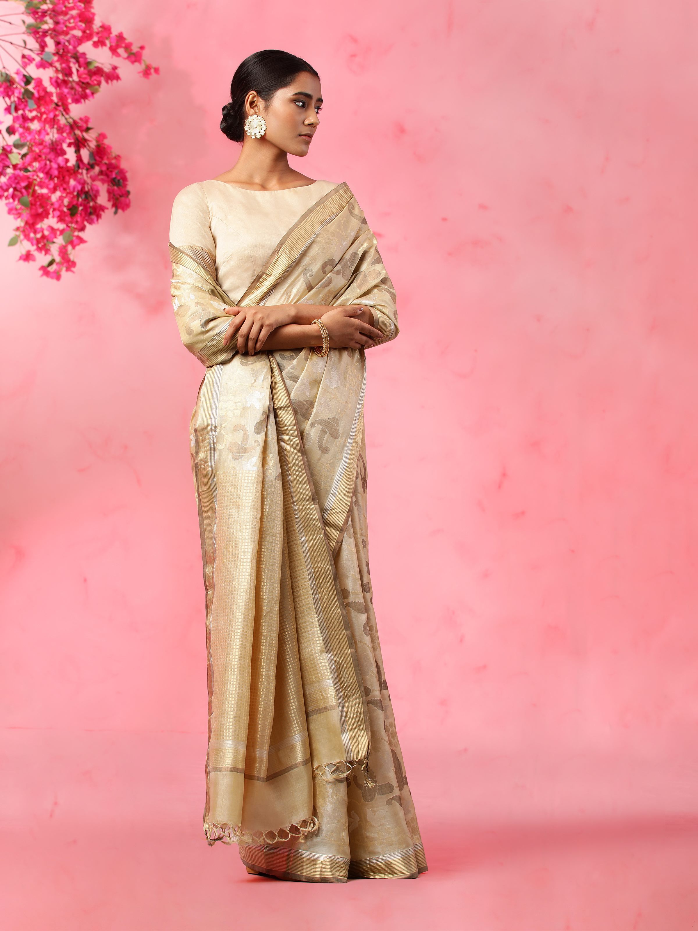Angled view of beige tussar silk saree showing intricate silk texture and fall
