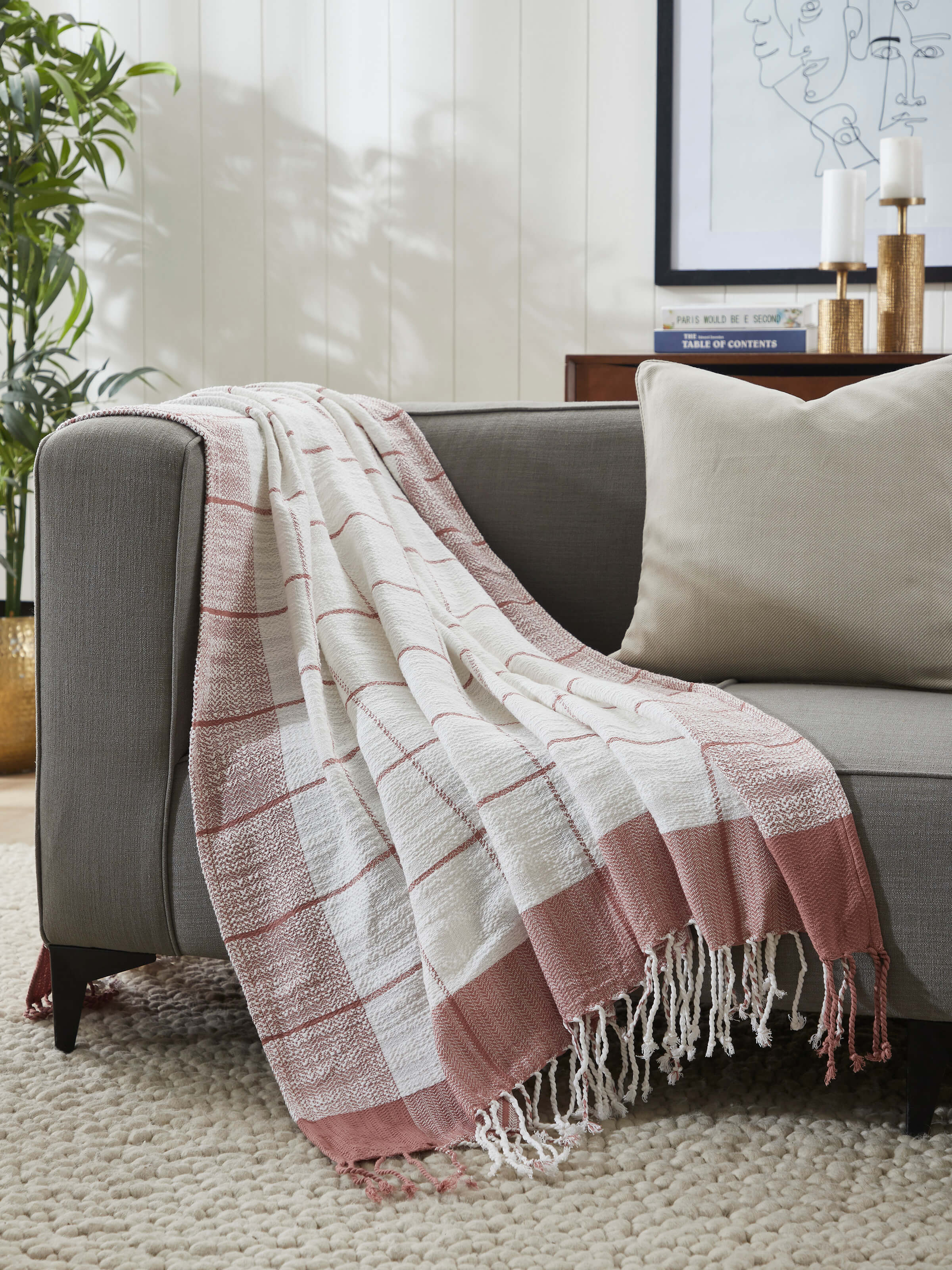 Interior setting showcasing Adhima throw draped on a chair for cozy decor.