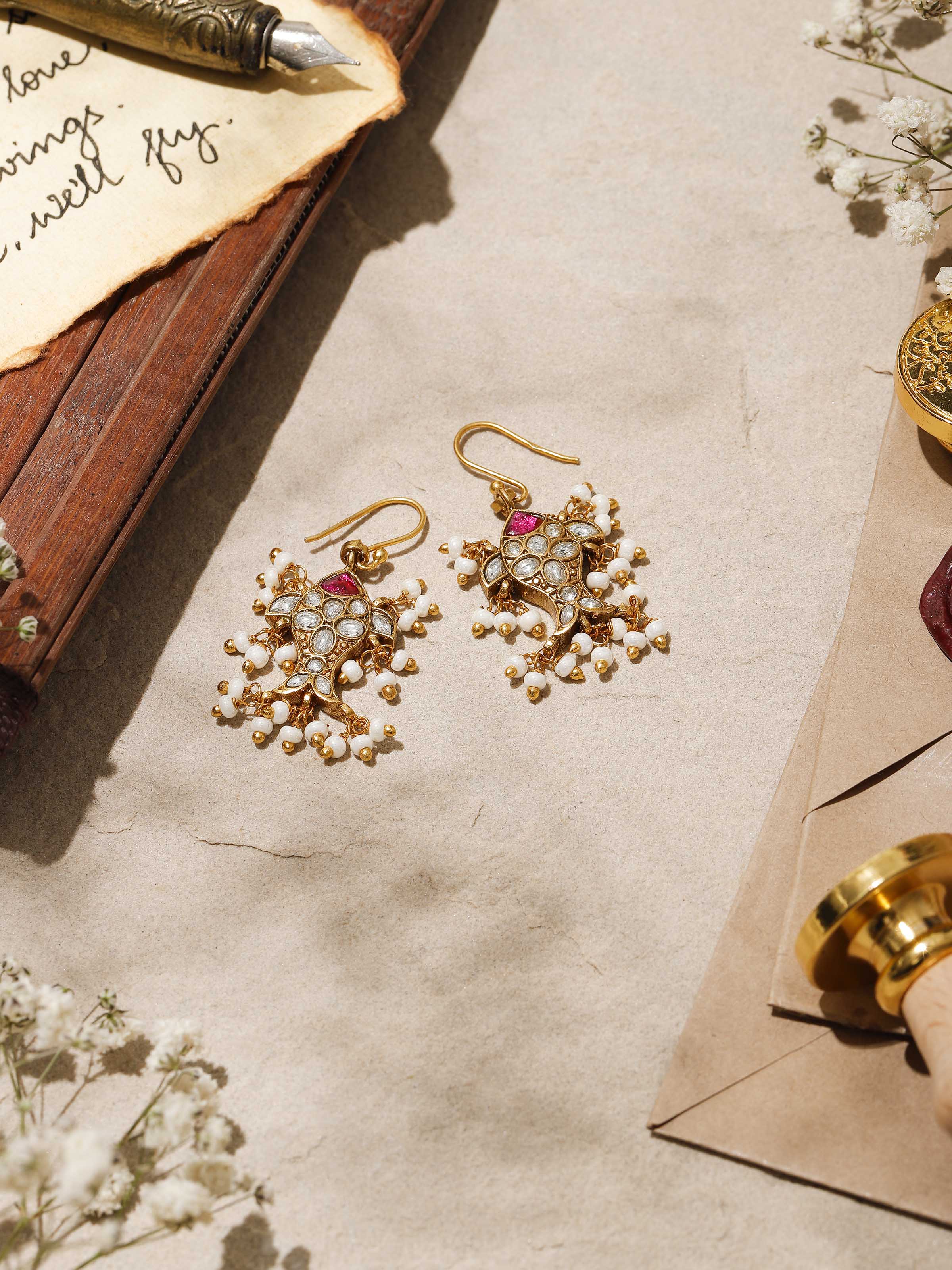 Angled shot highlighting the detailed silverwork and smooth finish of the earrings