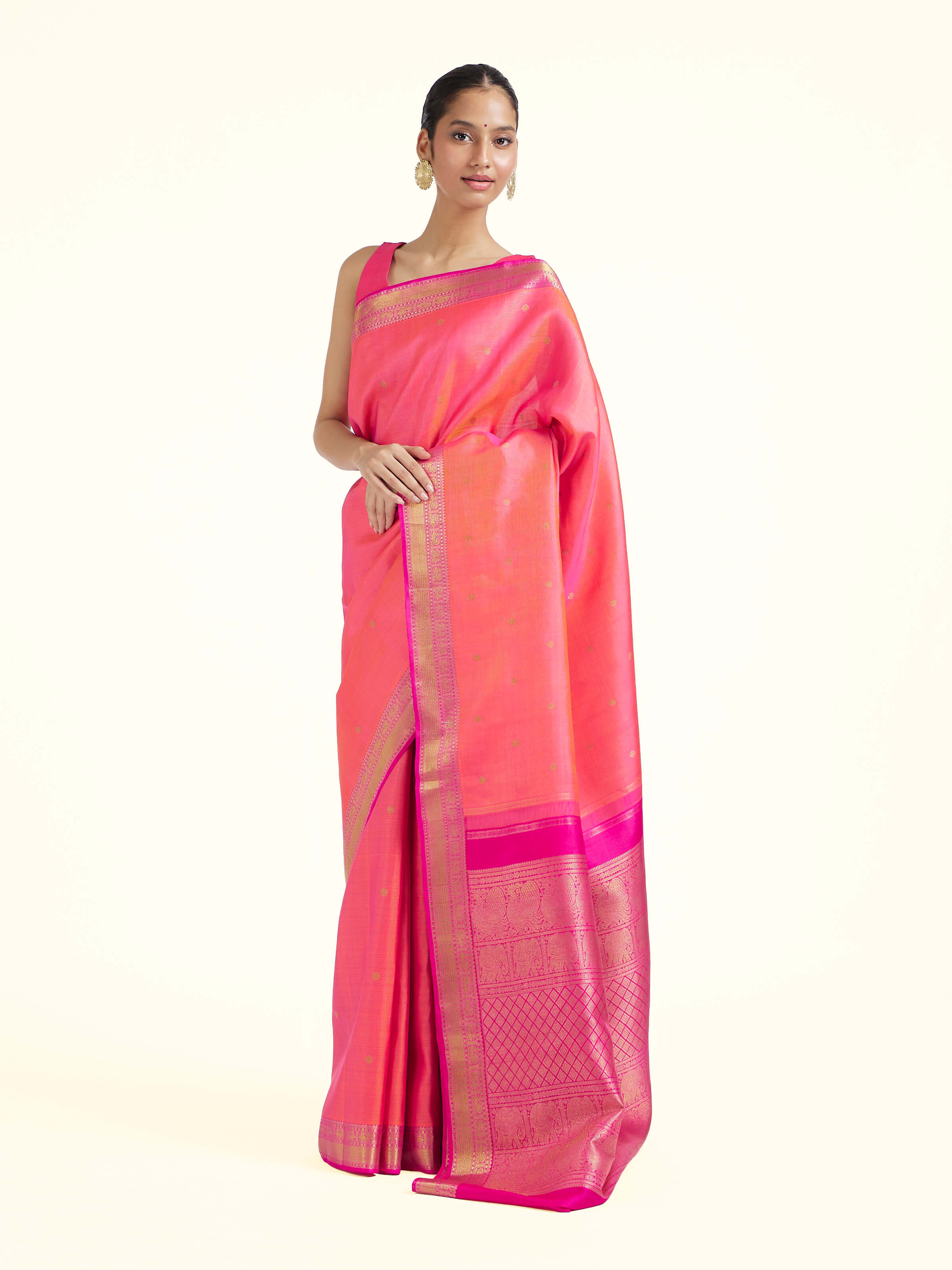 Side view of pink silk Kancheepuram saree with graceful drape and traditional border