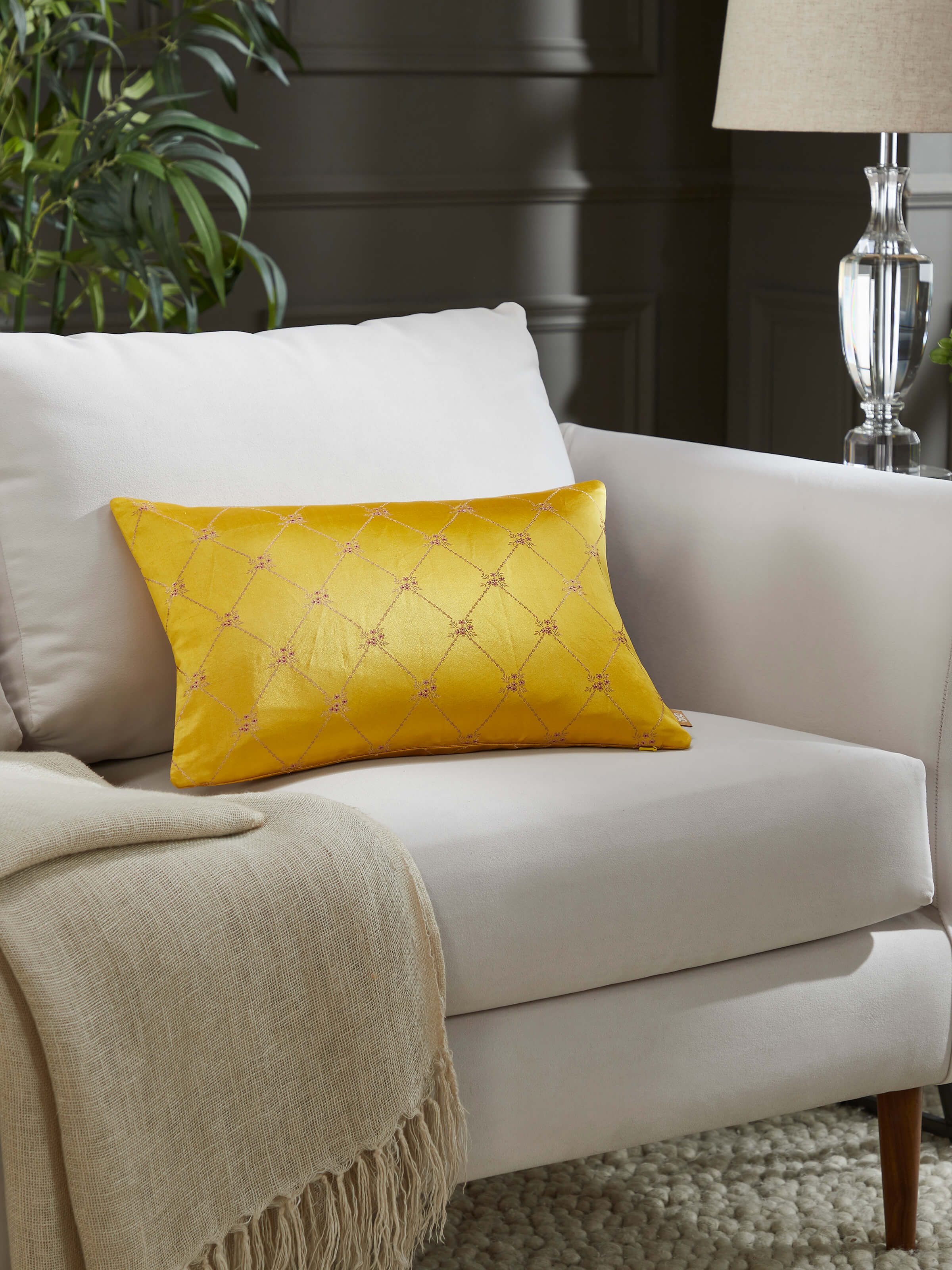 Sofa setup highlighting Awadh silk cushion in handloom Banarasi weave.