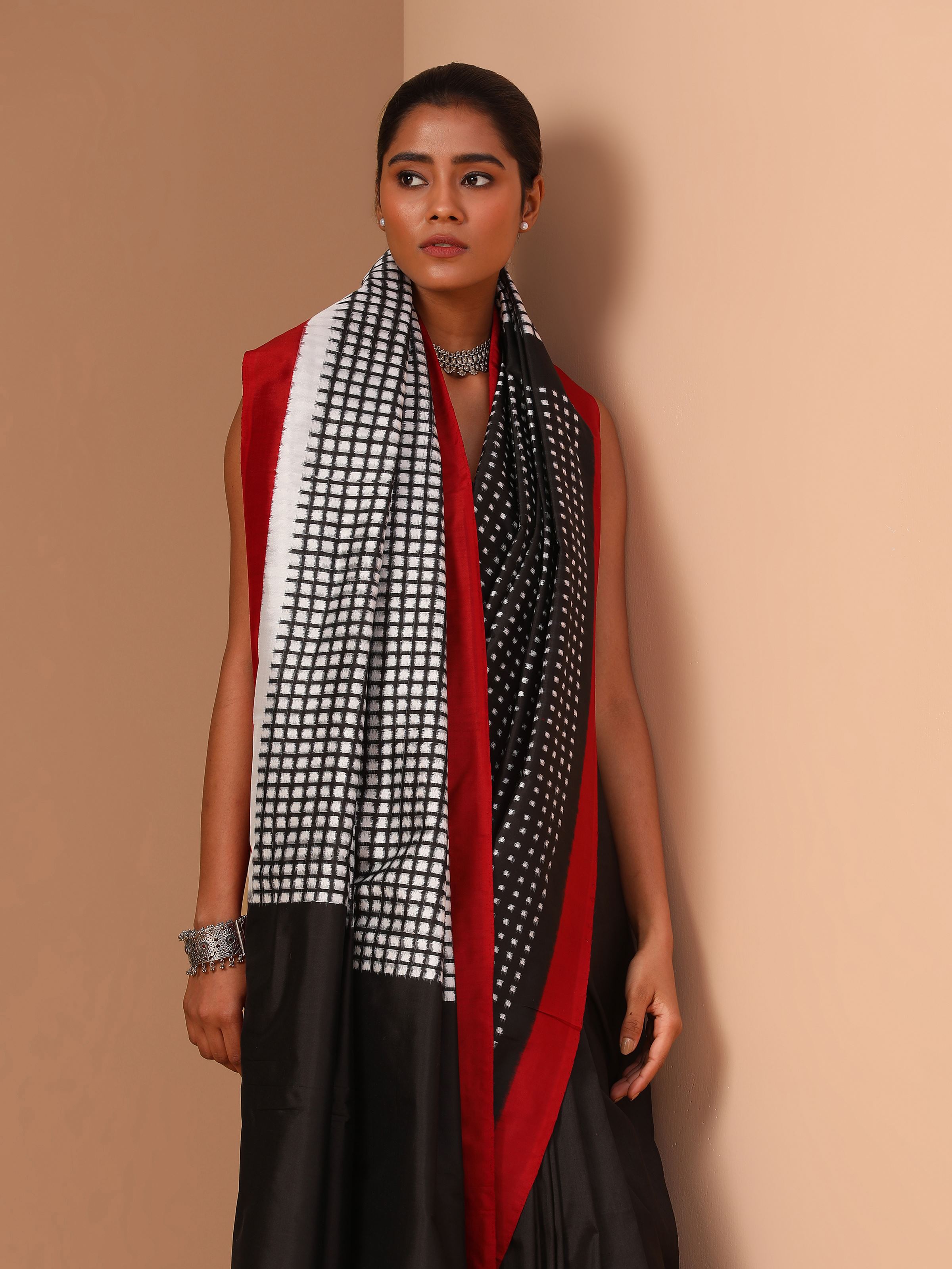 Close-up view of double ikat weaving and motifs on black silk saree fabric