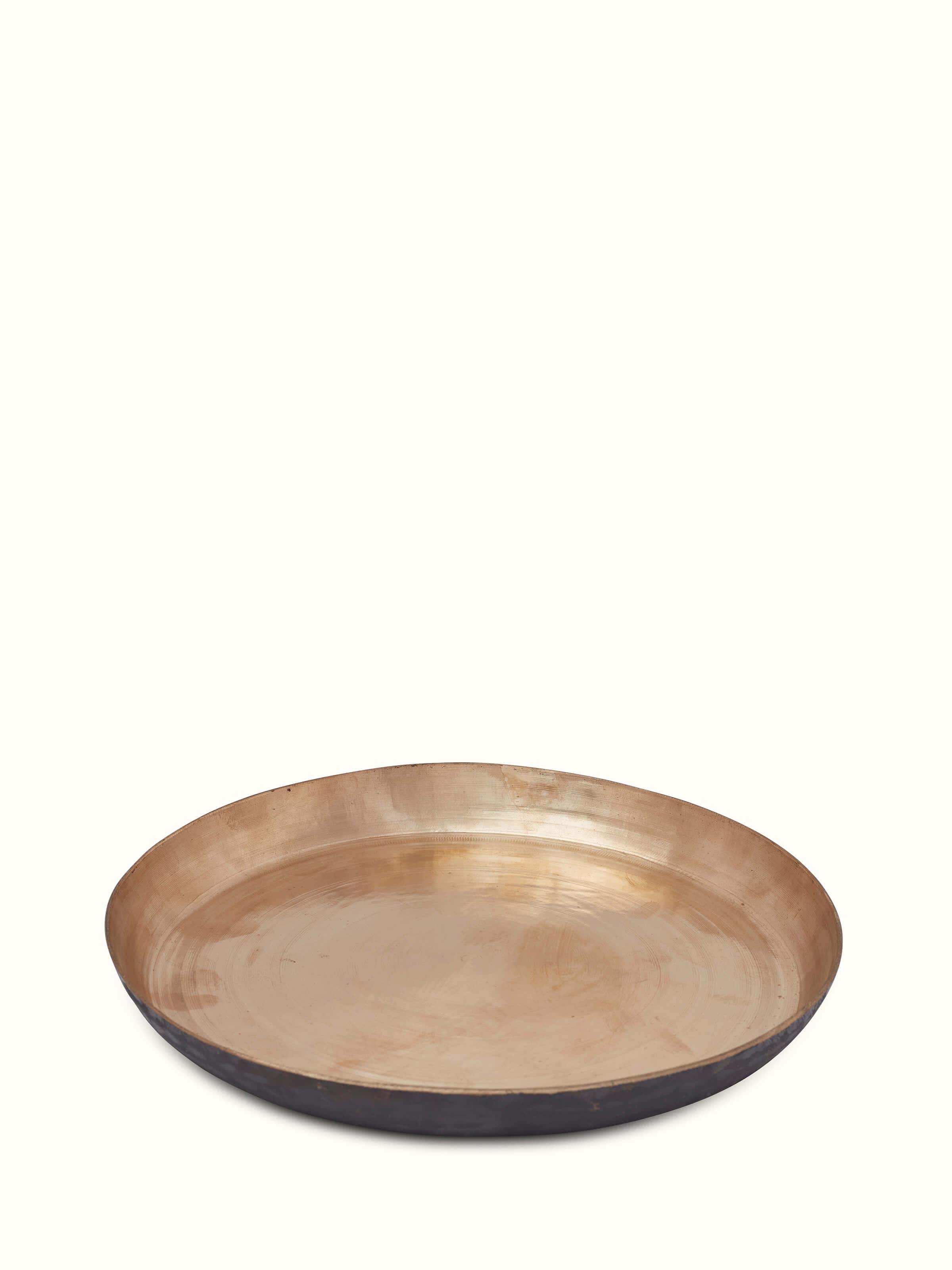 Side view of bell metal dinner plate emphasizing craftsmanship and polished finish