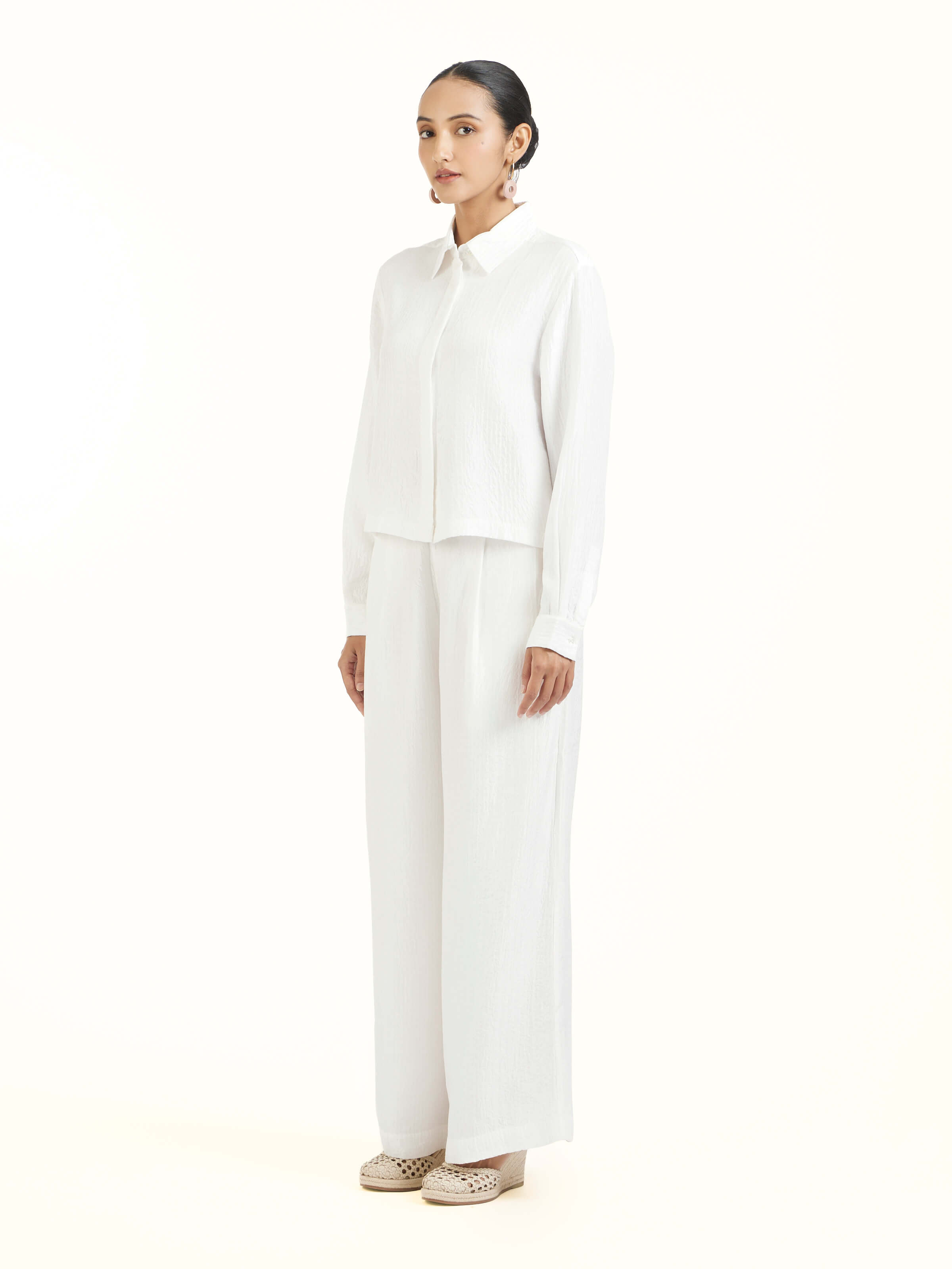 Side view of ivory quilted silk shirt showcasing tailored silhouette