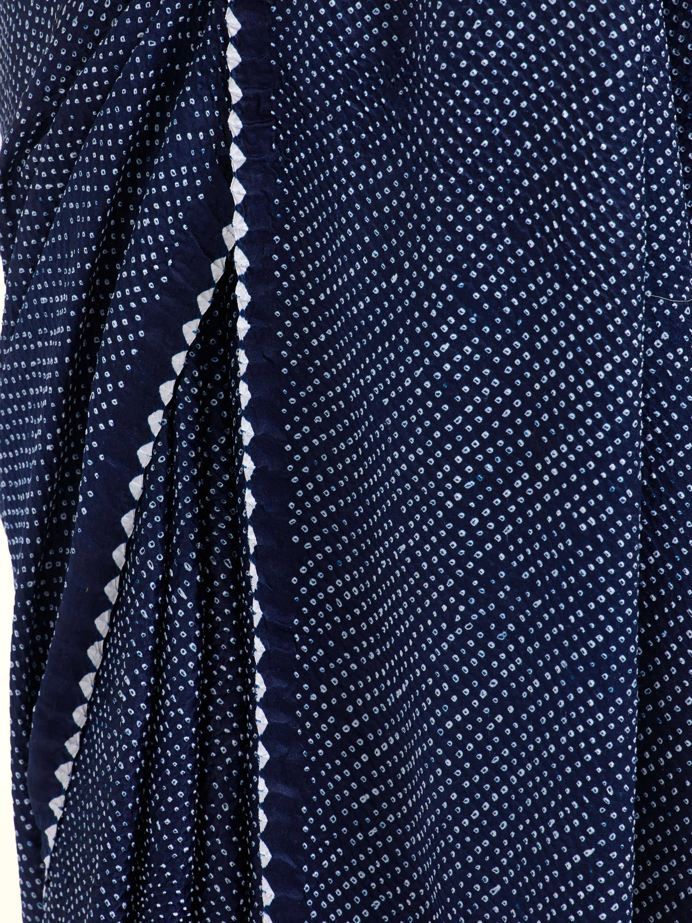 Detail view of black silk tie and dye bandhani saree showing fabric texture