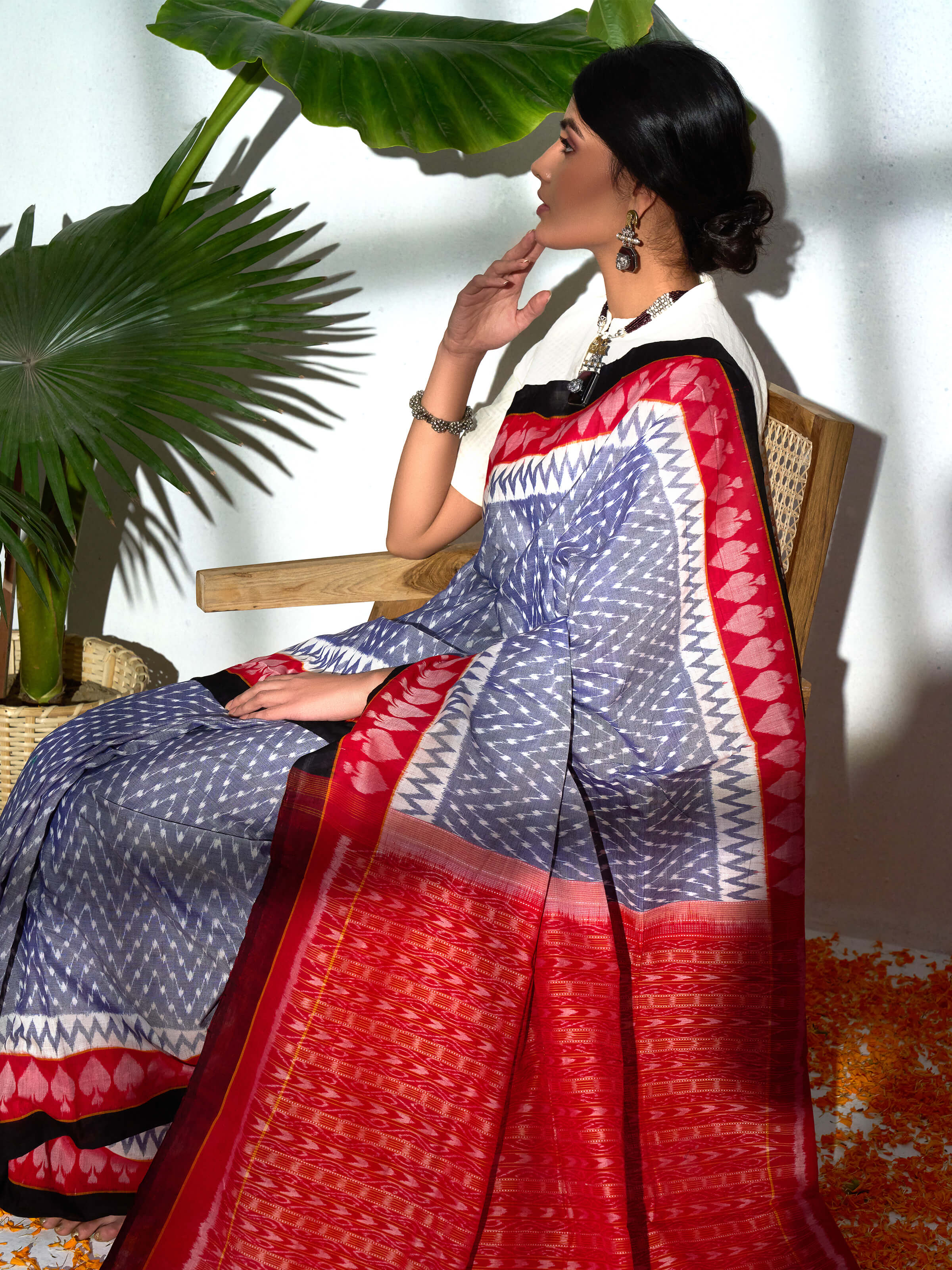Angled view of grey cotton bandha Odisha ikat saree highlighting ikat motifs