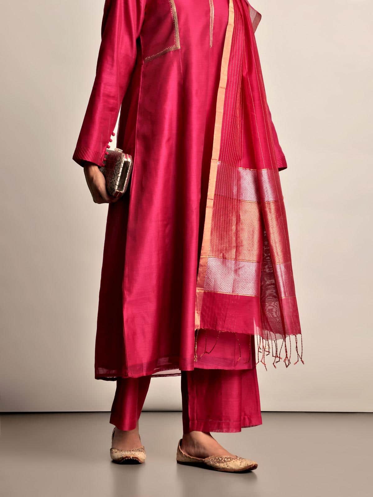 Side lifestyle view of fuschia cotton silk palazzo highlighting relaxed fit and texture