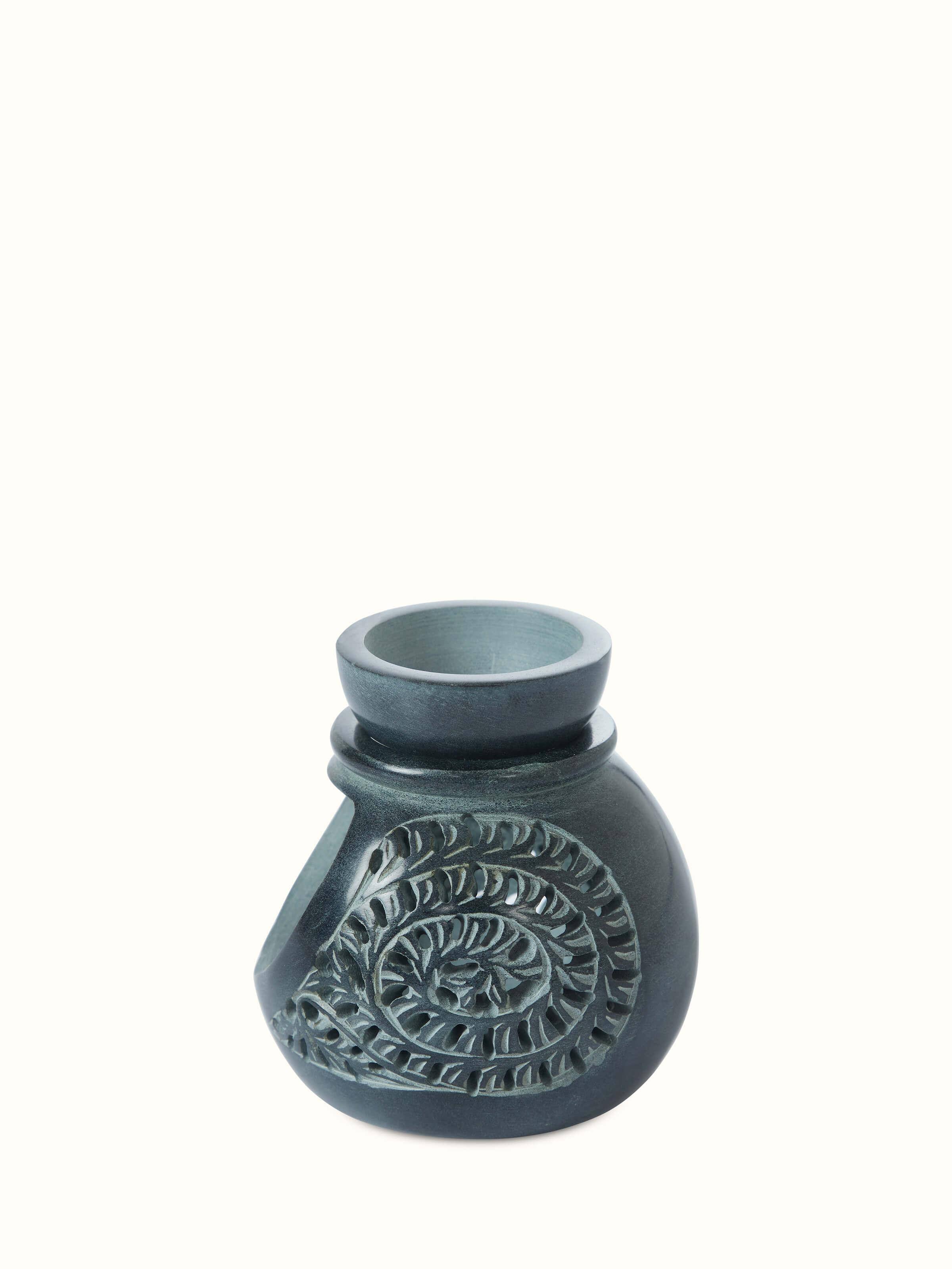 Detailed close-up of Carved soapstone aroma oil burner focusing on the texture and intricate carvings