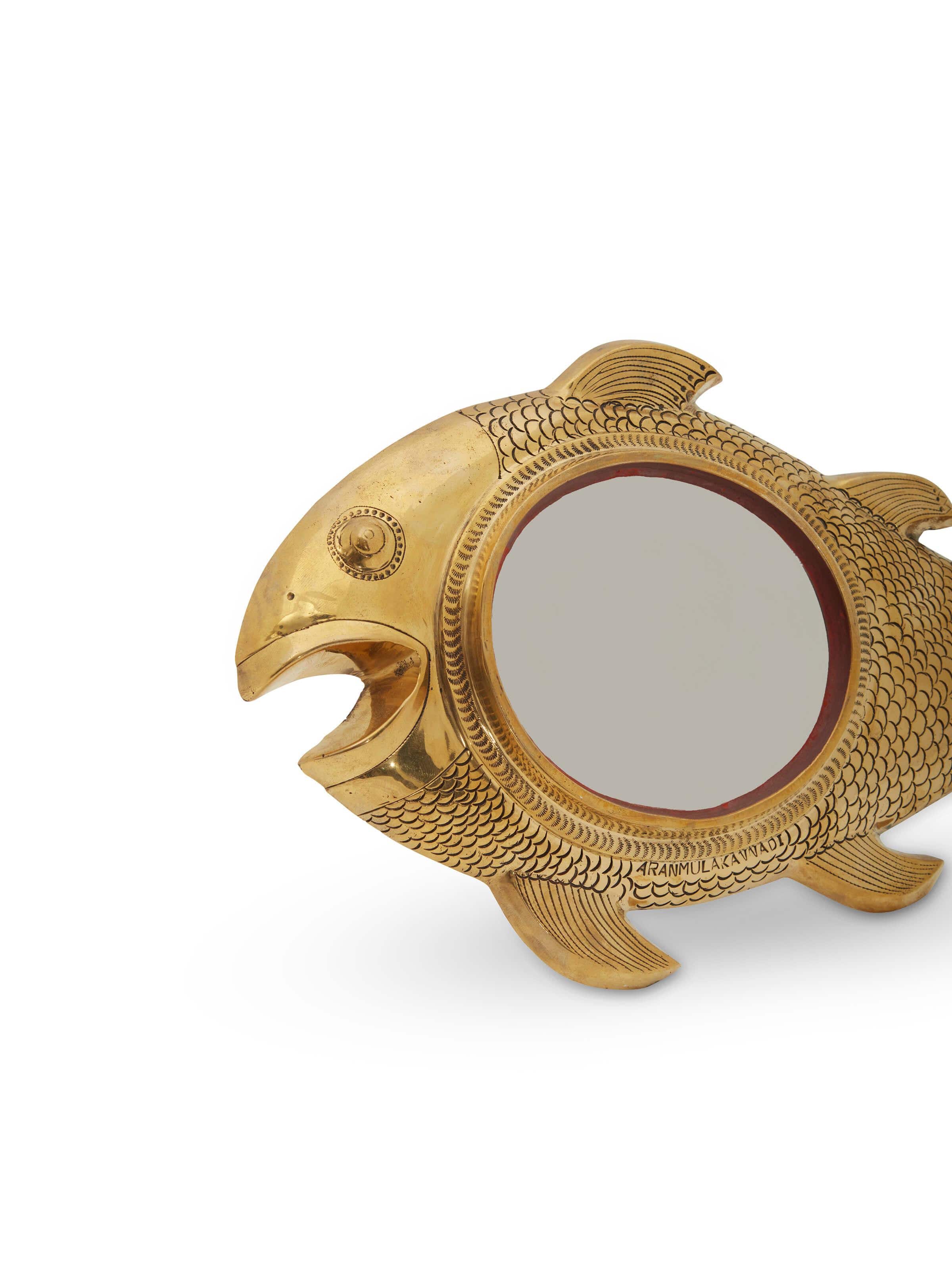 Close-up of Aranmula kannadi brass mirror focusing on its intricate design.