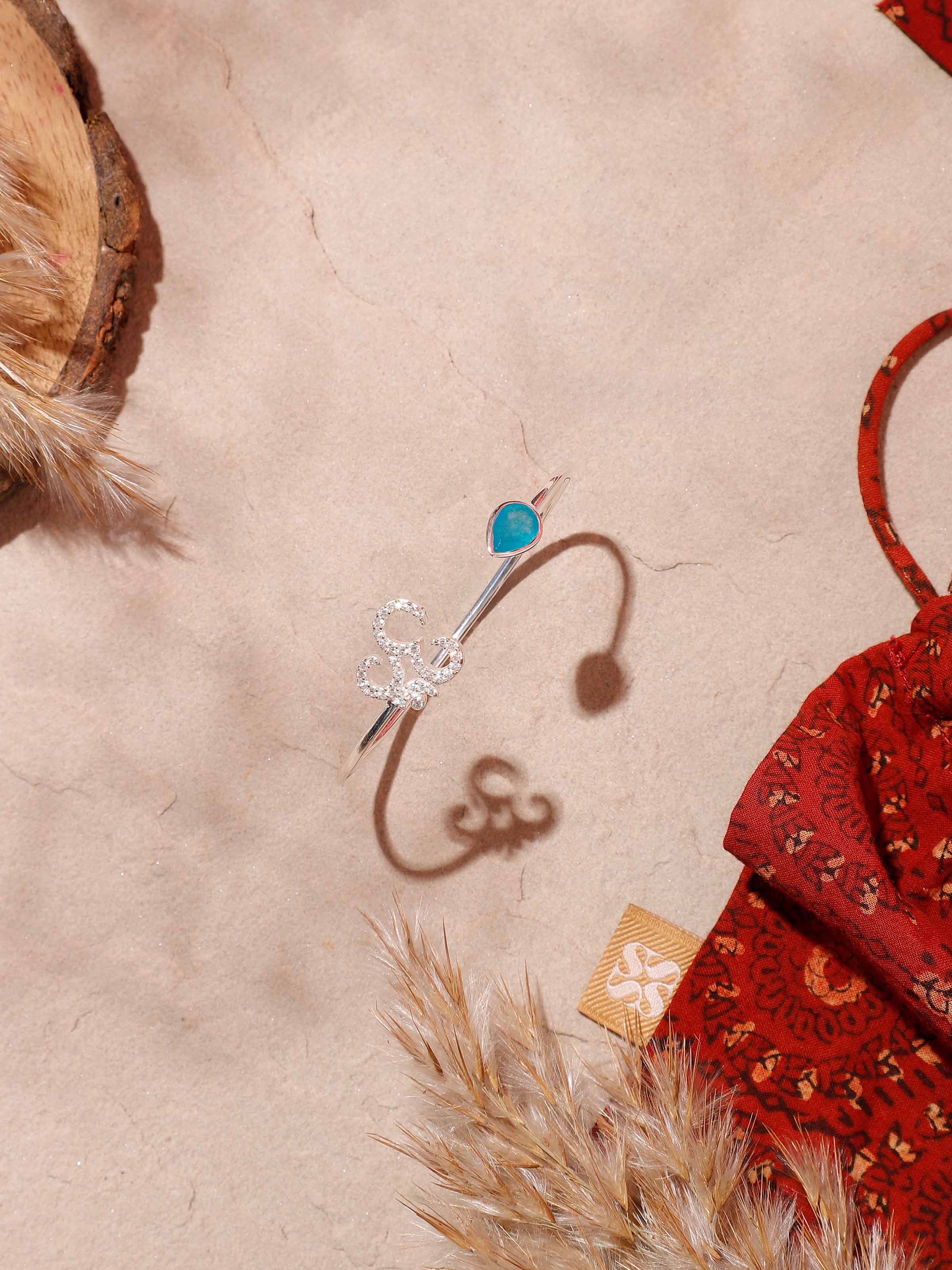 Lifestyle image of Green White Jade Om bracelet styled on wrist for spiritual healing and natural elegance