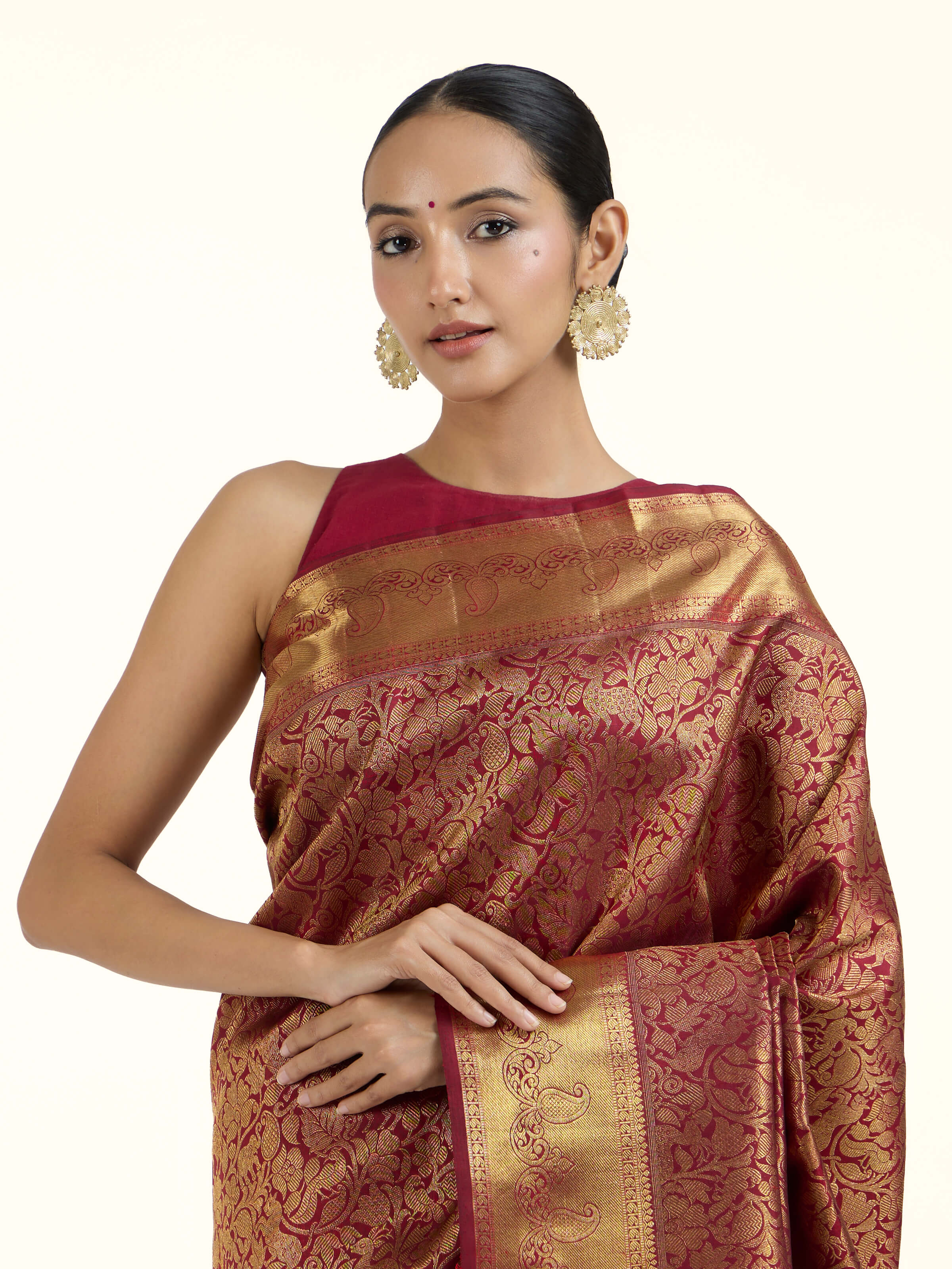Angled view of light pink silk Kancheepuram saree highlighting woven motifs