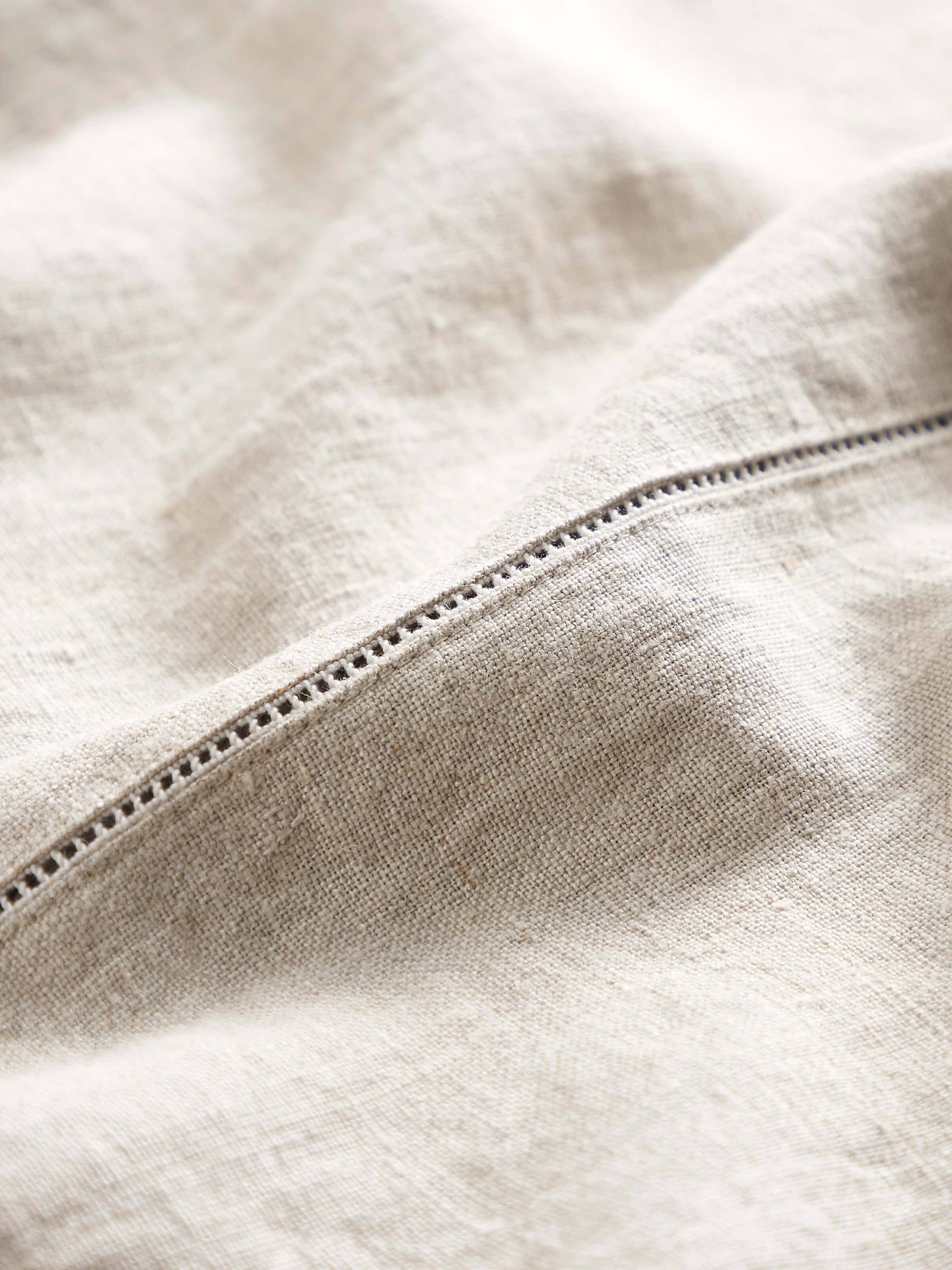 Side perspective emphasizing the embroidery depth and fabric quality