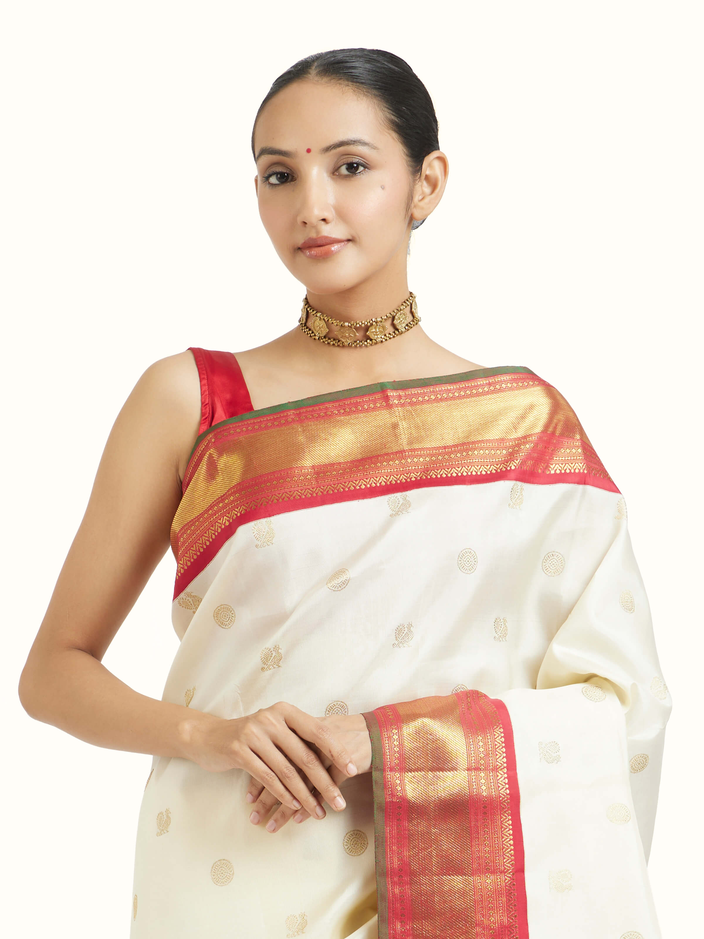 Angled view of off-white silk Kancheepuram saree highlighting traditional weave and sheen