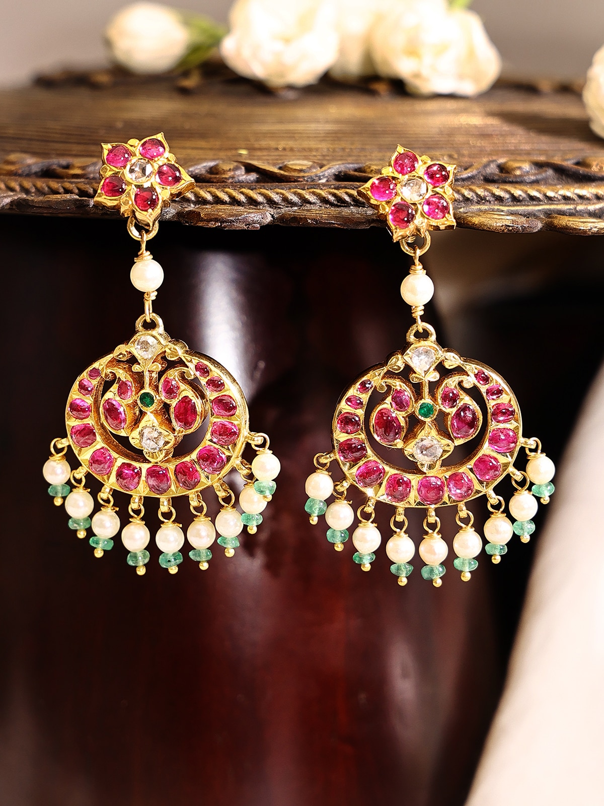 Side view of Kundala Velai 22 karat gold drop earrings highlighting their intricate details