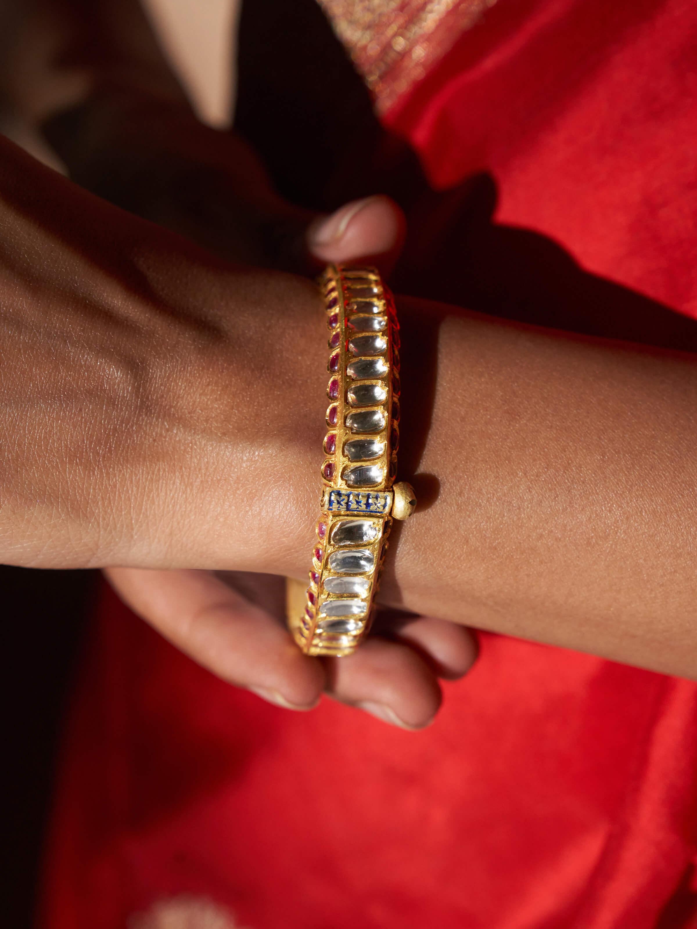 Close-up view of silversmithing long necklace highlighting detailed craftsmanship.