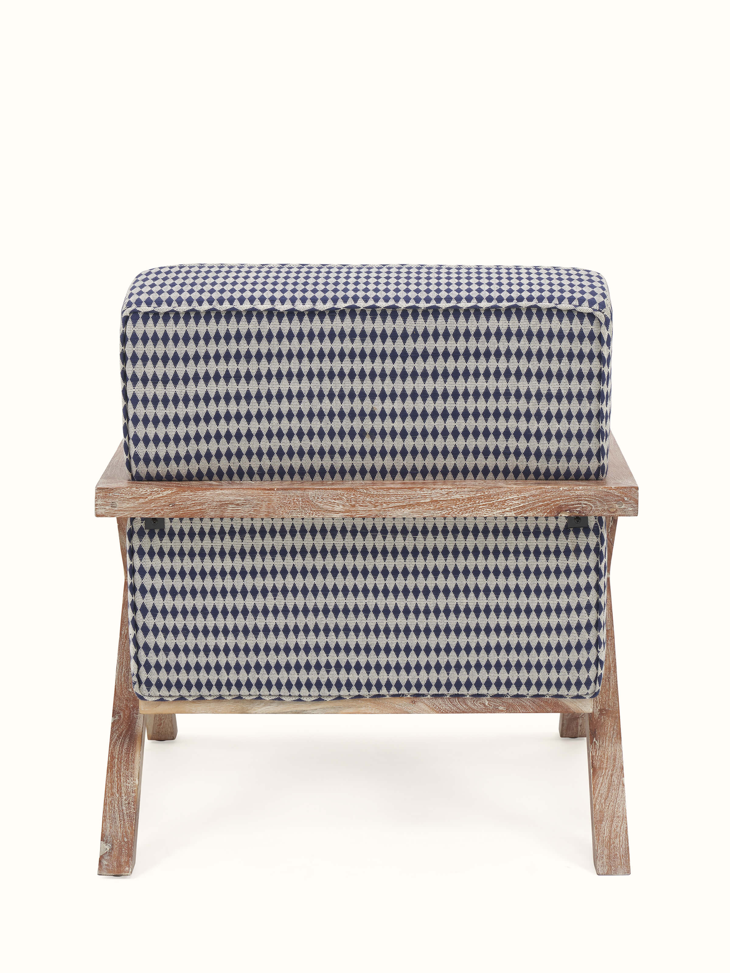 Angled back view of Swadesh Upholstered Acacia Wood Armchair showcasing its comfortable seat and detailed woodwork