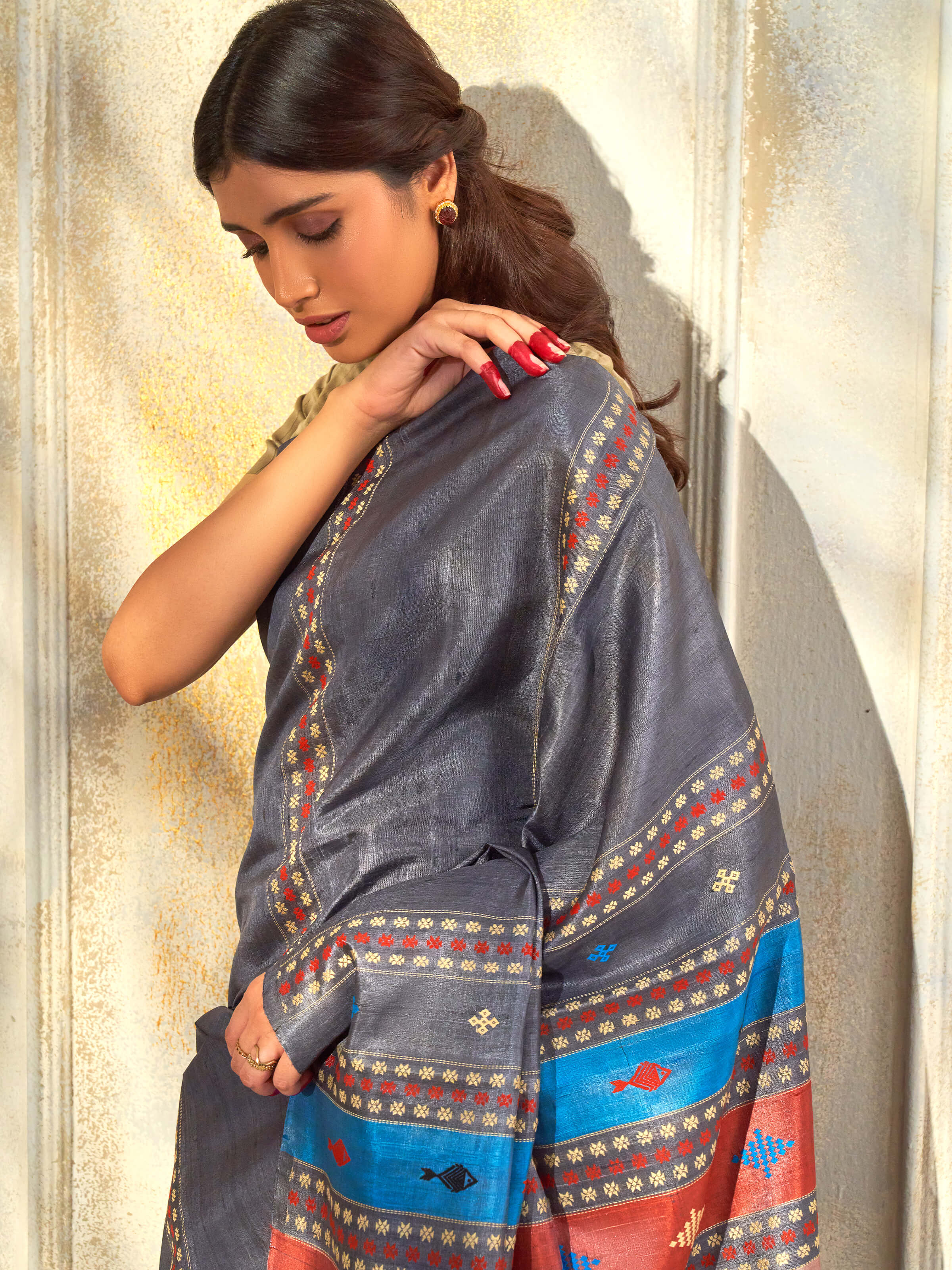 Angled view of black tussar silk extra-weft saree highlighting traditional weave and natural sheen