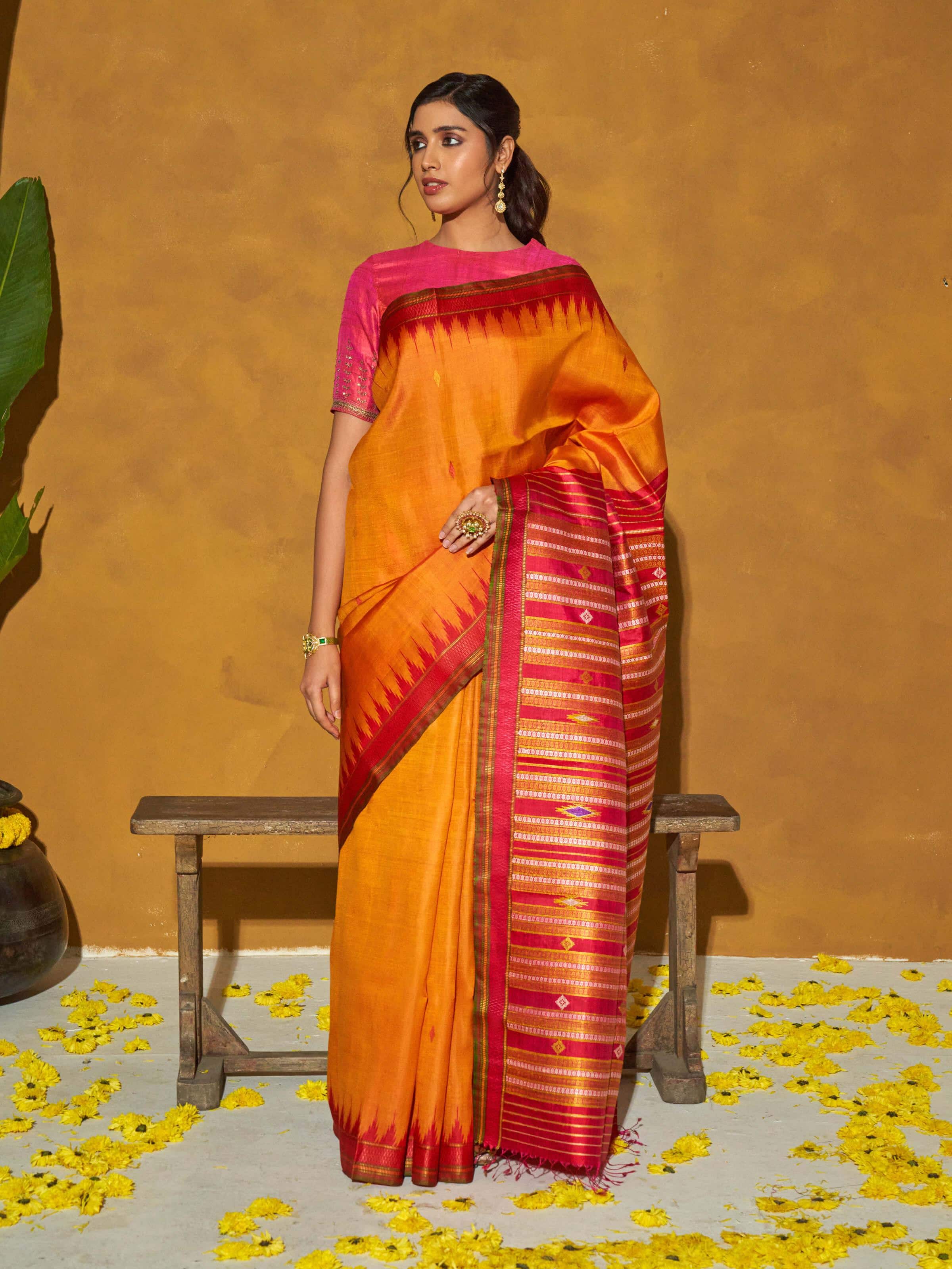 Side view of orange tussar silk bandha Odisha ikat saree highlighting detailed weaving and fabric texture