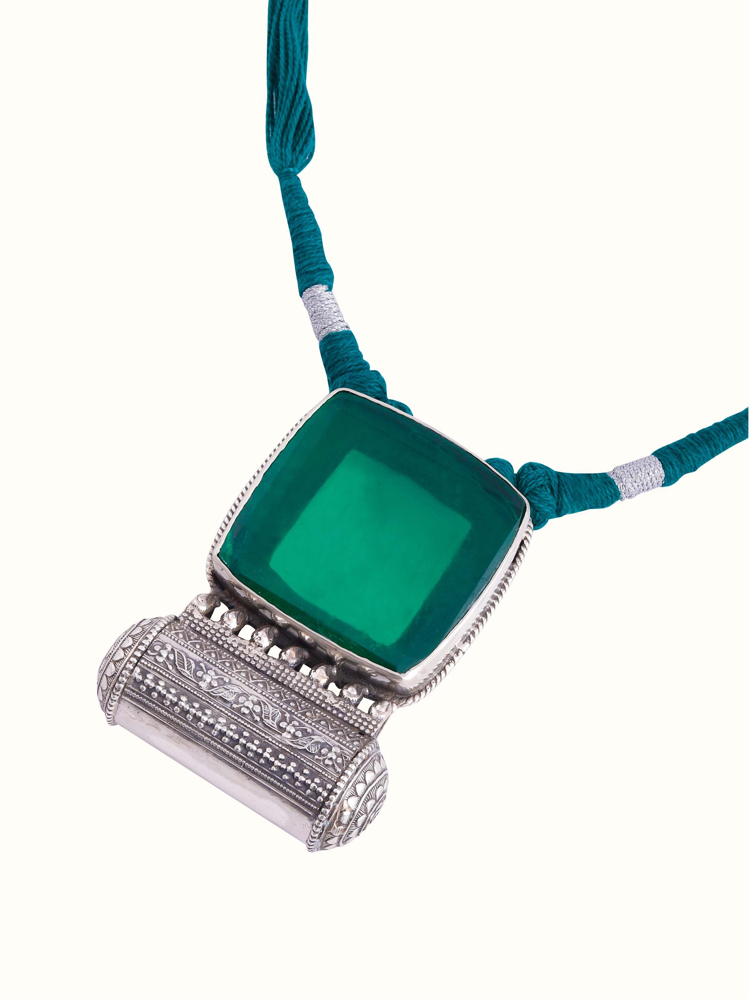 Overhead view of silver smithing collar necklace presenting its symmetry and bold character