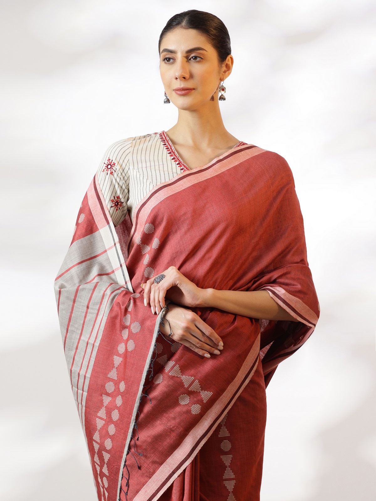 Close-up detail of Maroon Silk Extra-weft Saree showing intricate extra-weft design on silk fabric.
