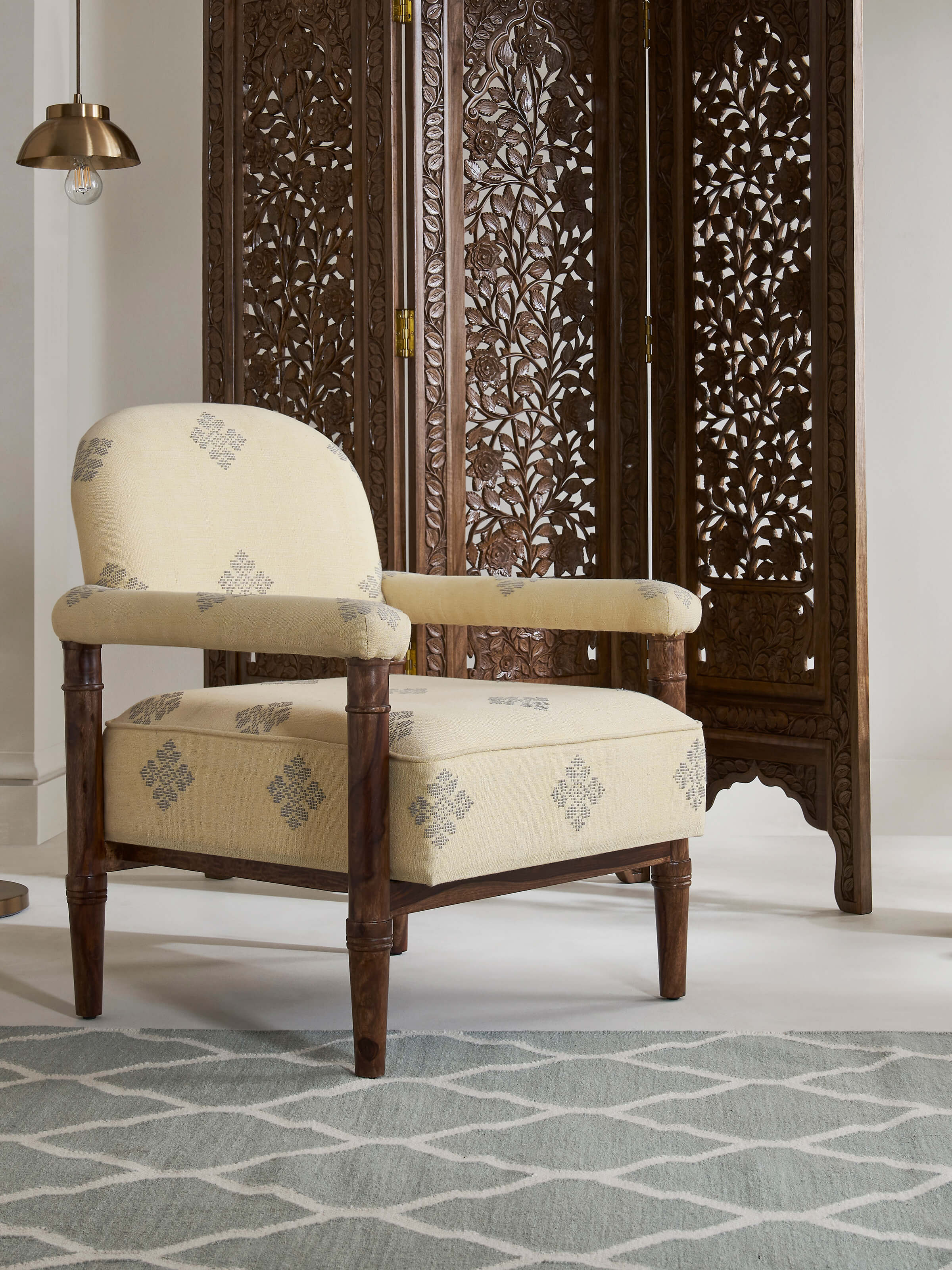 Side view of Upholstered Sheesham Wood Bawan Buti Armchair with intricate sheesham wood frame and plush upholstery.