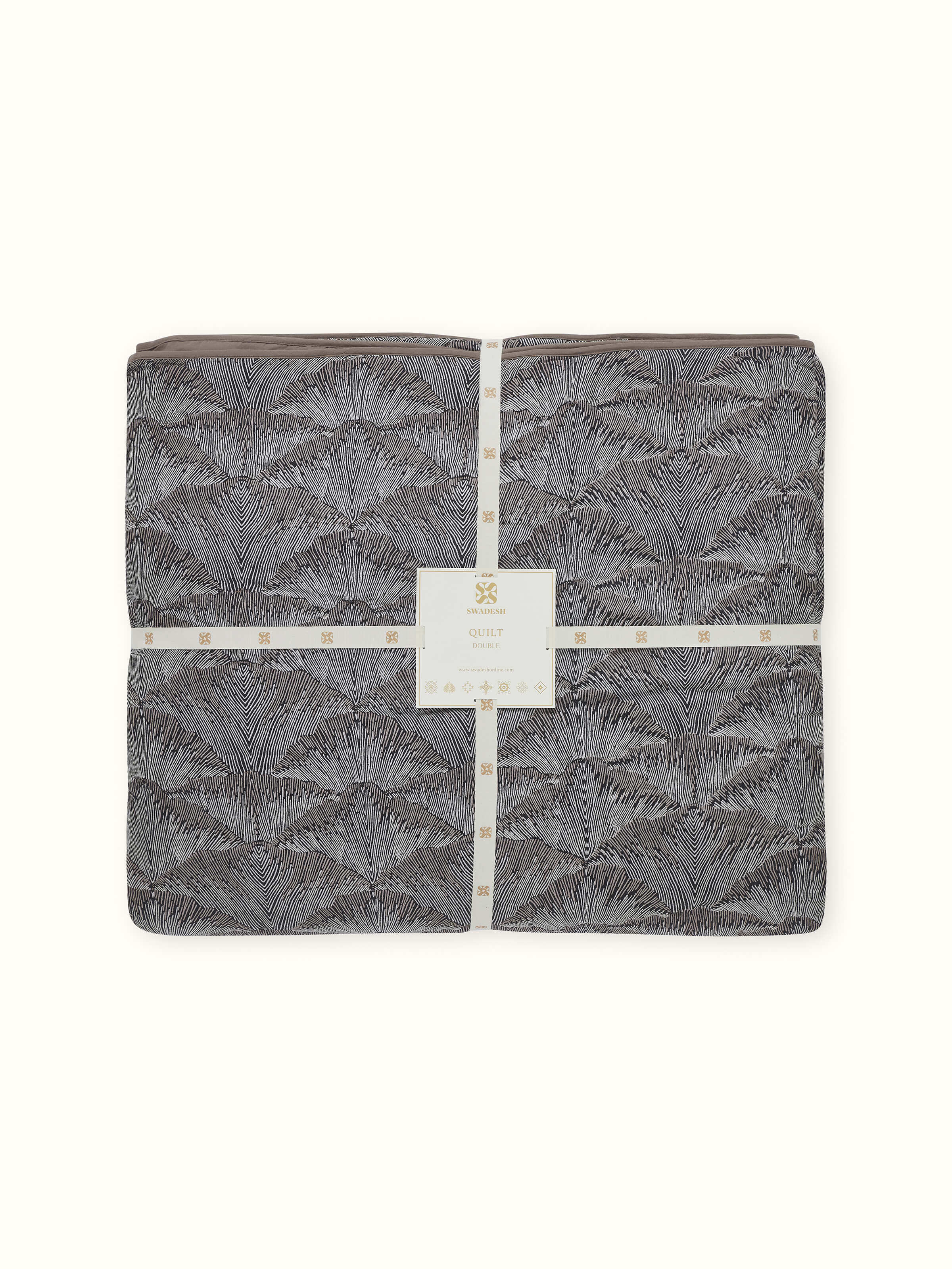 Close-up showing fine Sanganeri detailing on Parvat brown printed quilt fabric.