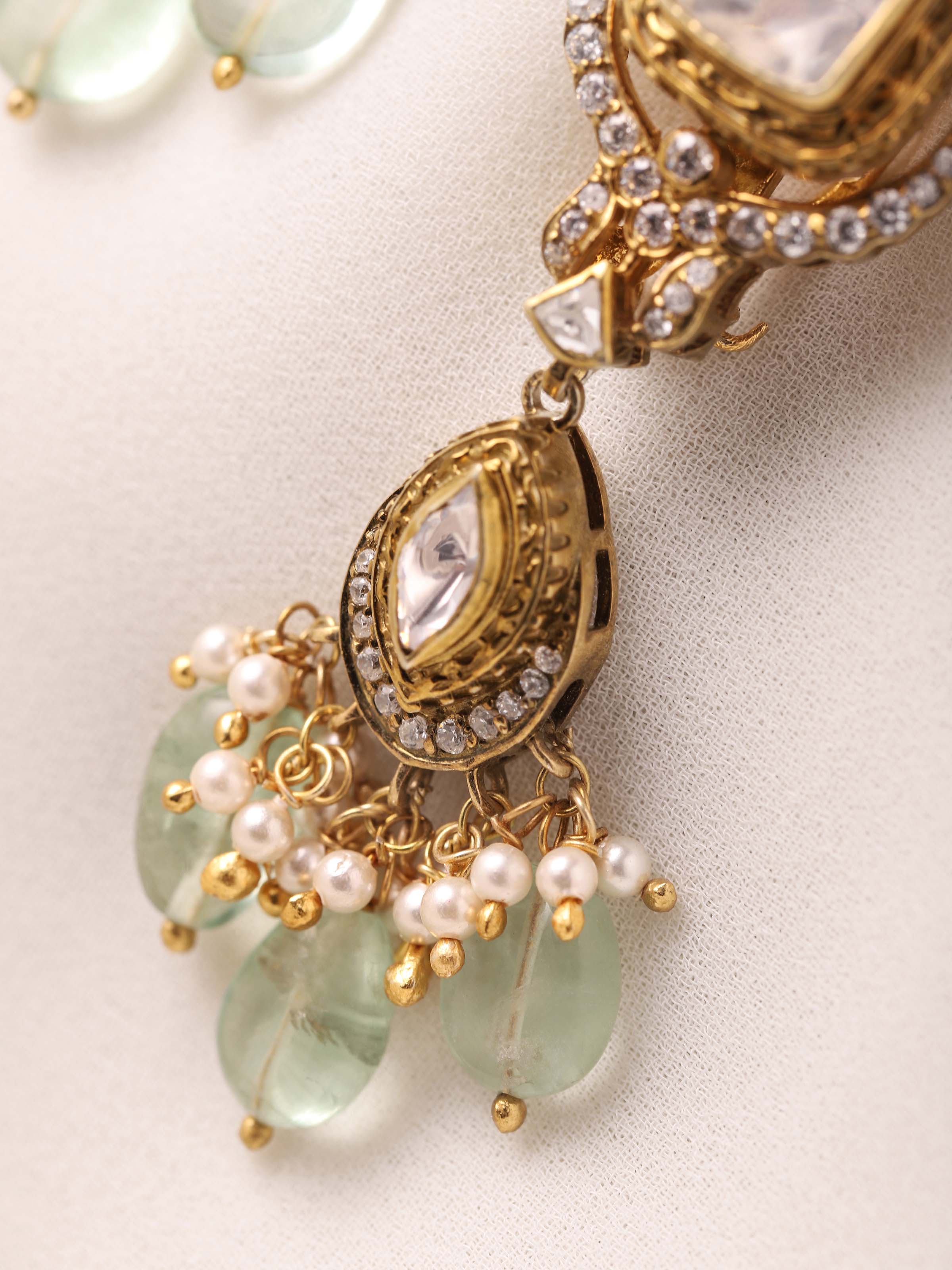 Close-up of Polki work on silver drop earrings