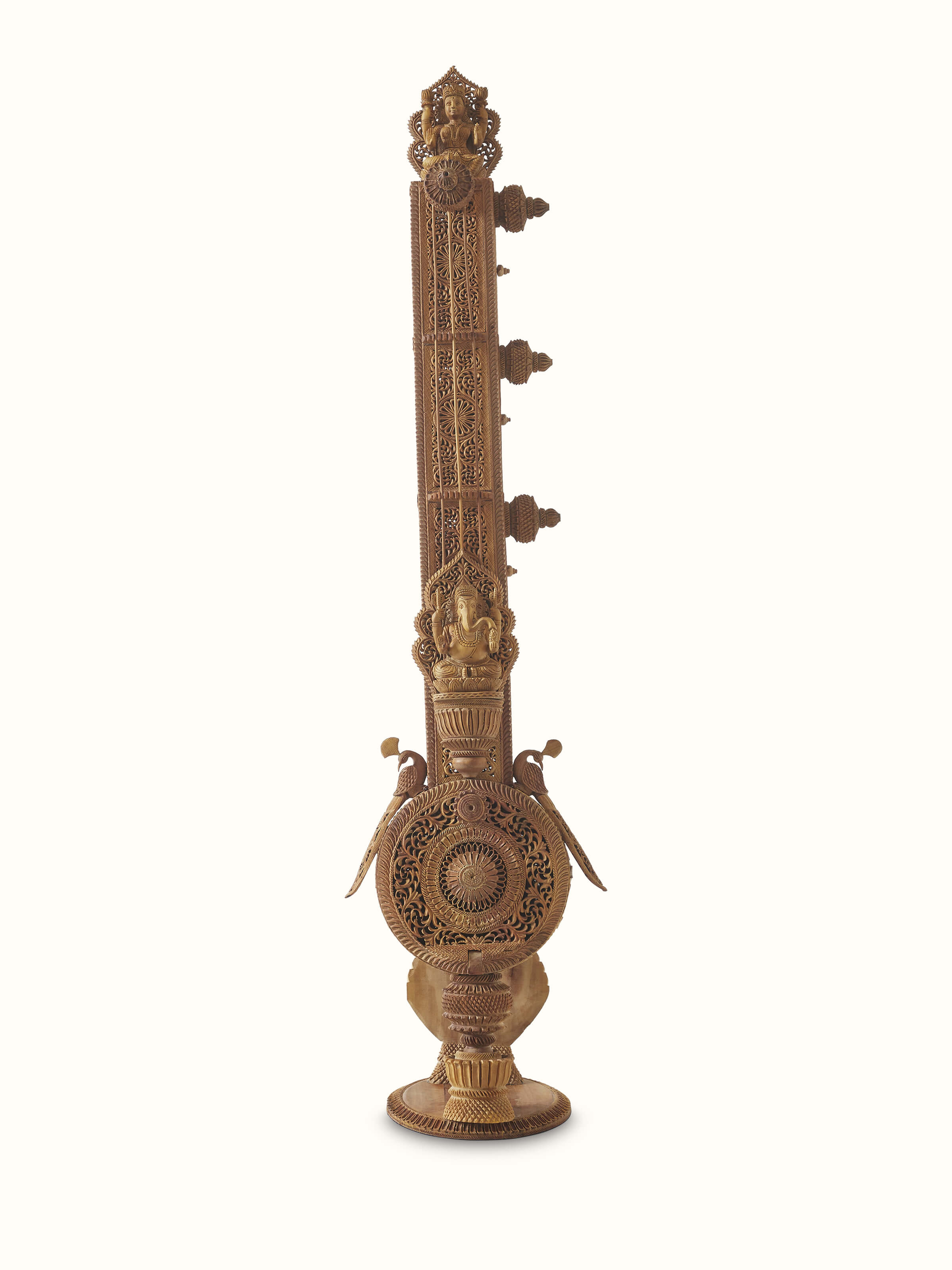 Front view of carved sandalwood veena sculpture, showcasing the fine craftsmanship and traditional artistry.