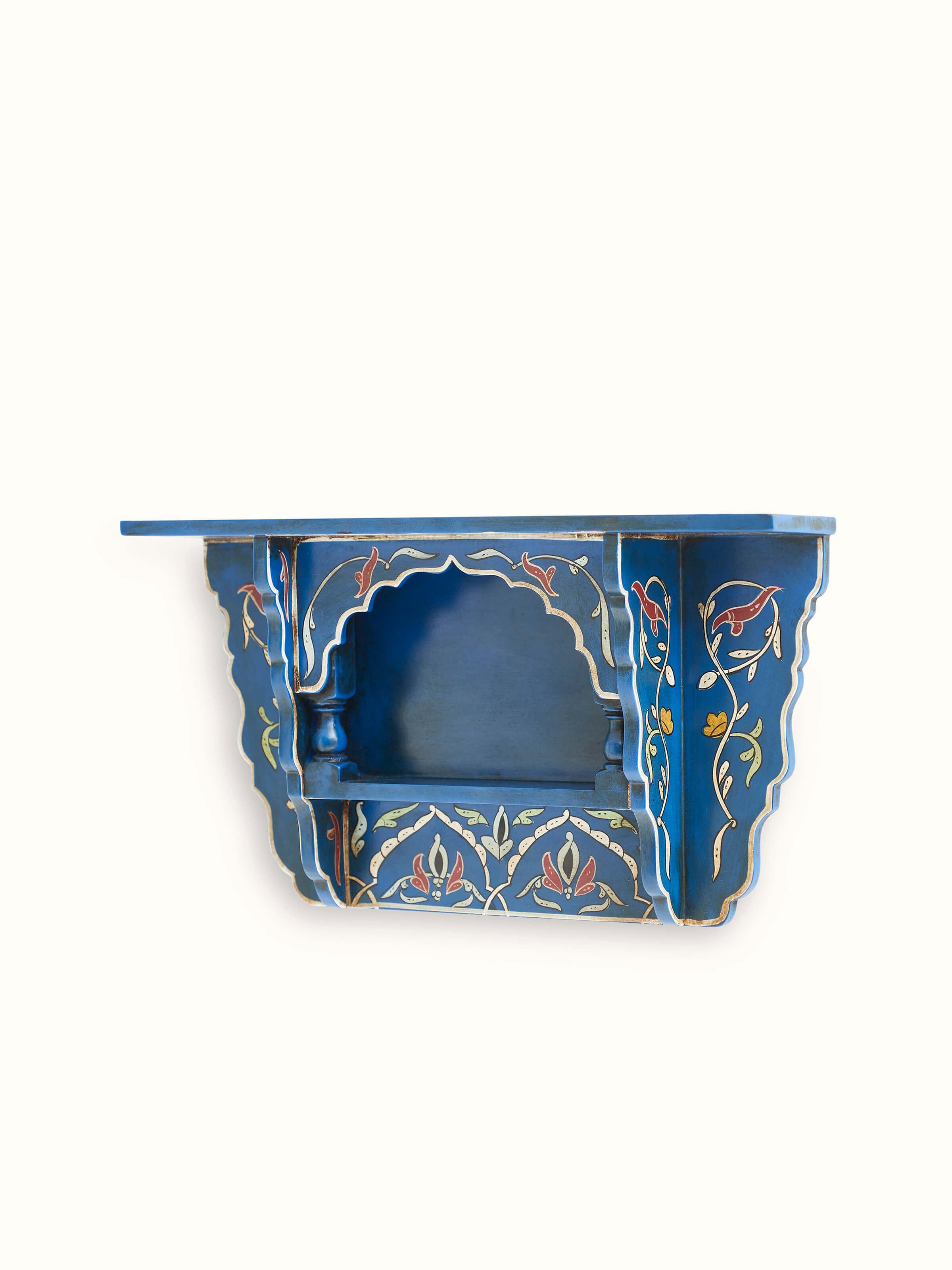 Angled view of Blue Miniature Painted Wall Shelf displaying its artistic design and intricate details.