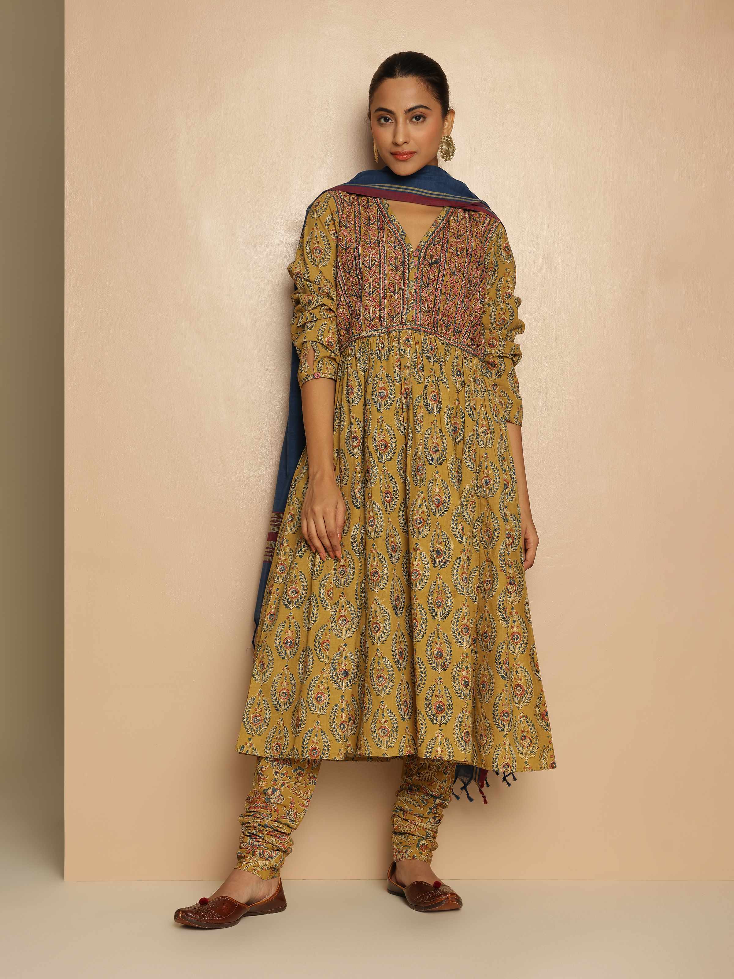 Lifestyle view of Yellow Cotton Kalamkari Block Printed Churidaar worn to show comfortable fit and traditional design.