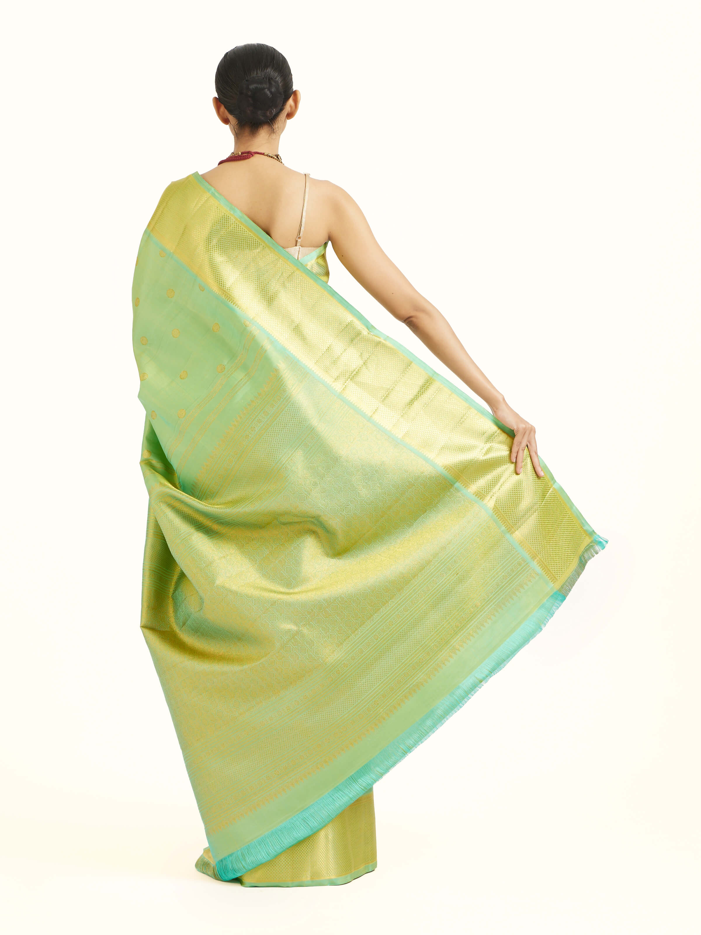 Back view of green silk Kancheepuram saree displaying ornate pallu design