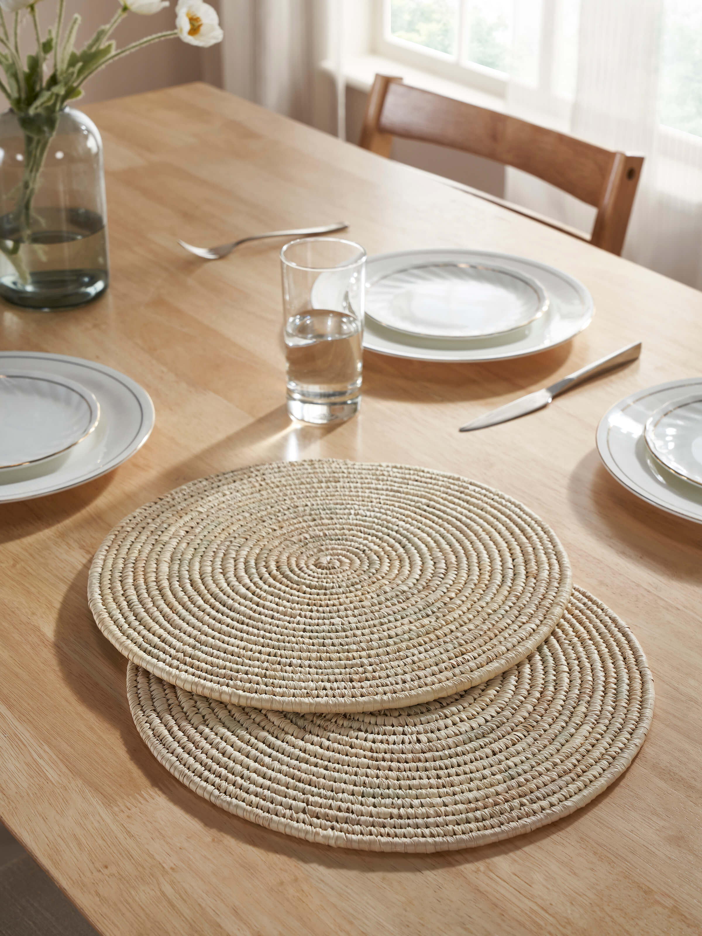 Top-down view showing the full round shape of the table mats with smooth natural fibre finish