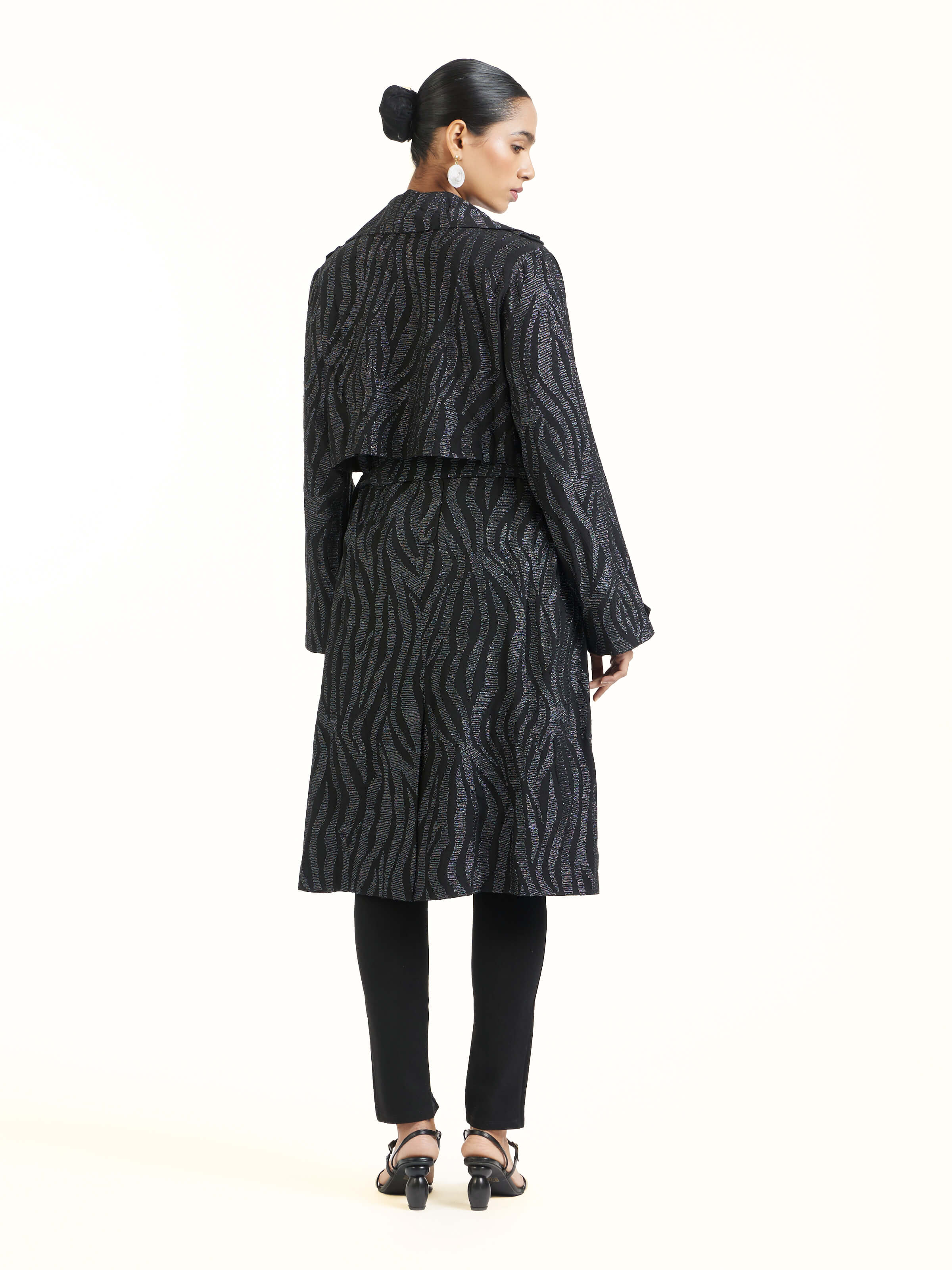 Back view of black aari hand embroidered trenchcoat displaying full length and design