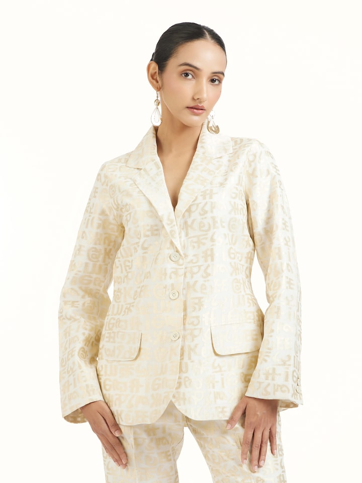 Angled view of ivory handloom cut work calligraphy co-ord set emphasizing cut work detailing
