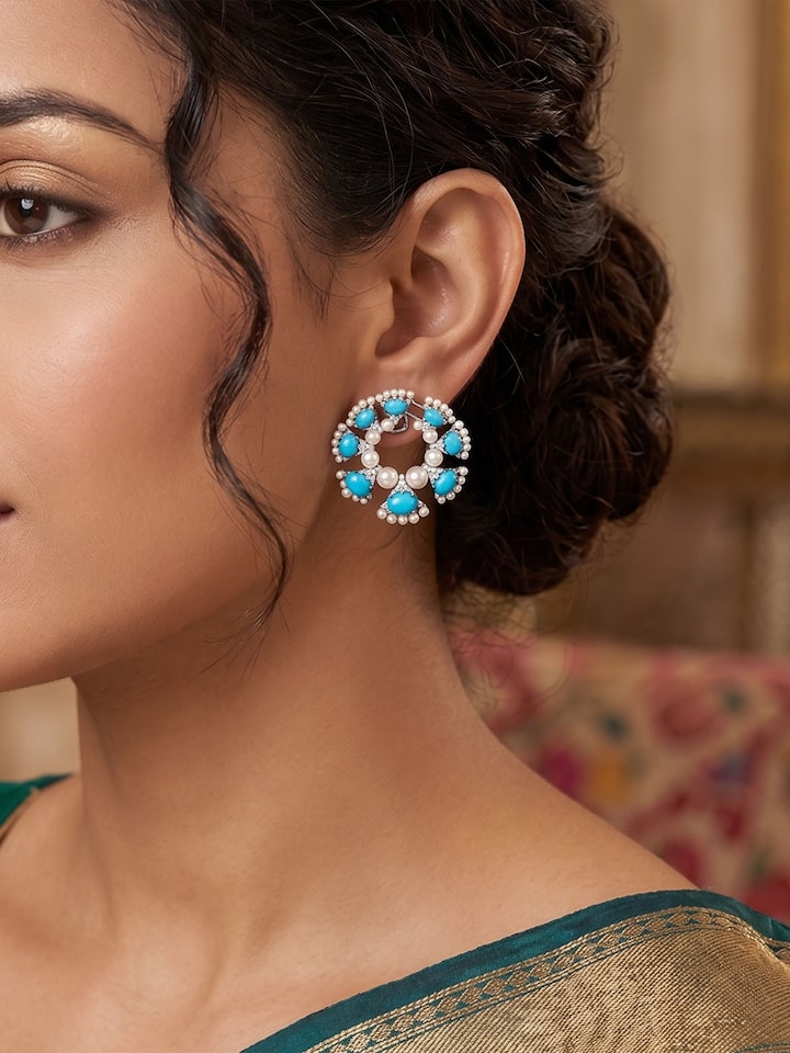 Styled view of Silver Smithing Stud Earrings worn on the ear, showing how it looks styled, from a different angle