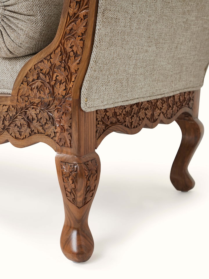 Top view of the handloom fabric upholstered carved walnut wood daybed, displaying the upholstered surface and wood carvings