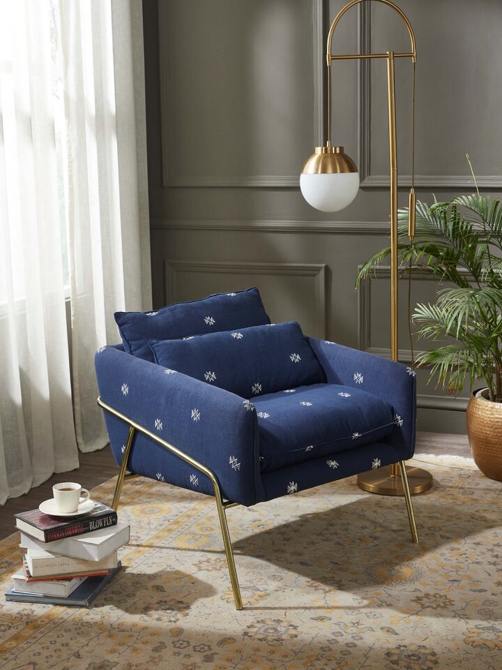 Side view of Upholstered Metal Armchair showcasing the comfortable seat and modern metal frame structure.