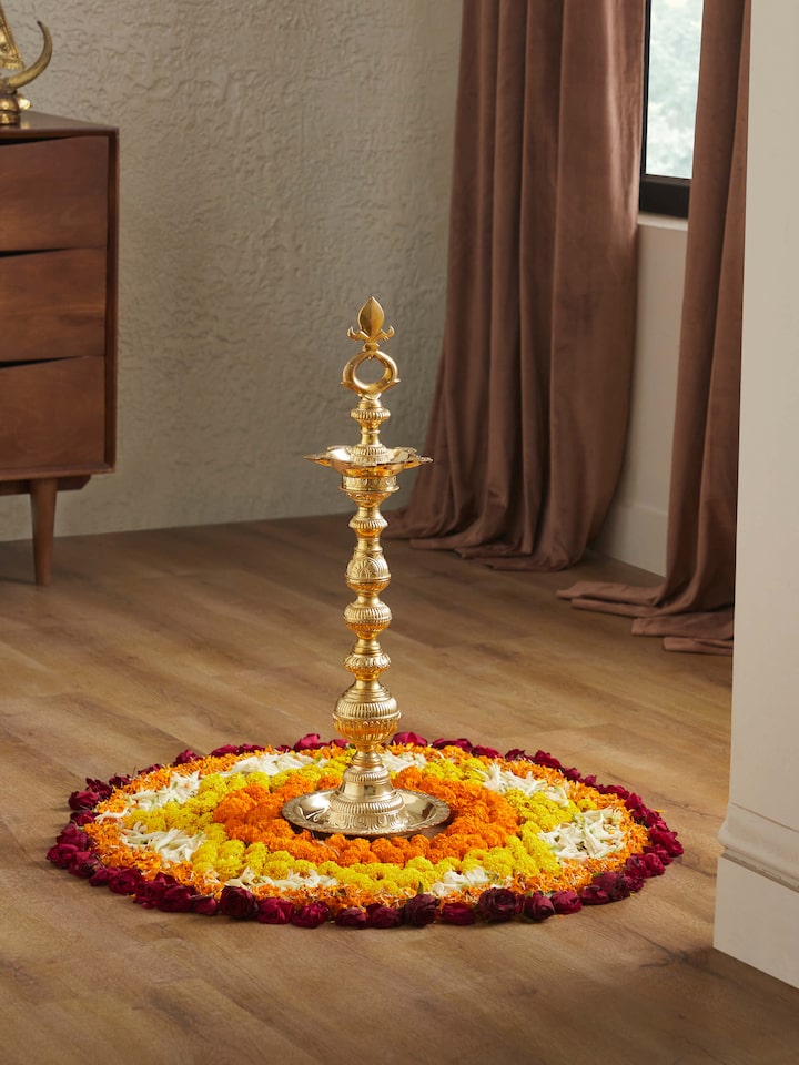Side view of Vilakku Carved Brass Stand Diya emphasizing its detailed carving and elegant stand.
